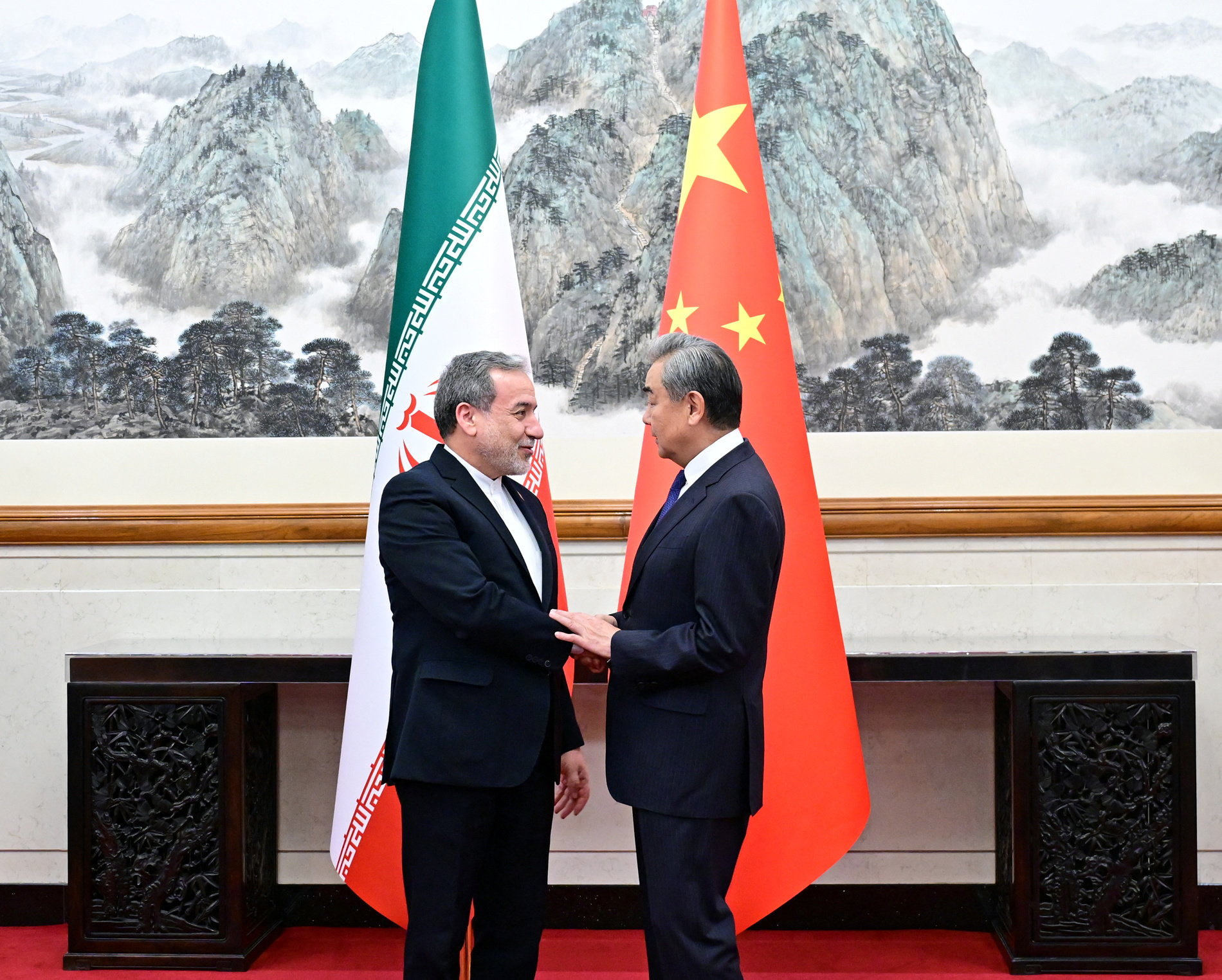 Chinese Foreign Minister Wang Yi and Iranian Foreign Minister Abbas Araqchi shake hands in Beijing, China, in this handout image released by China's Ministry of Foreign Affairs May 6, 2026.