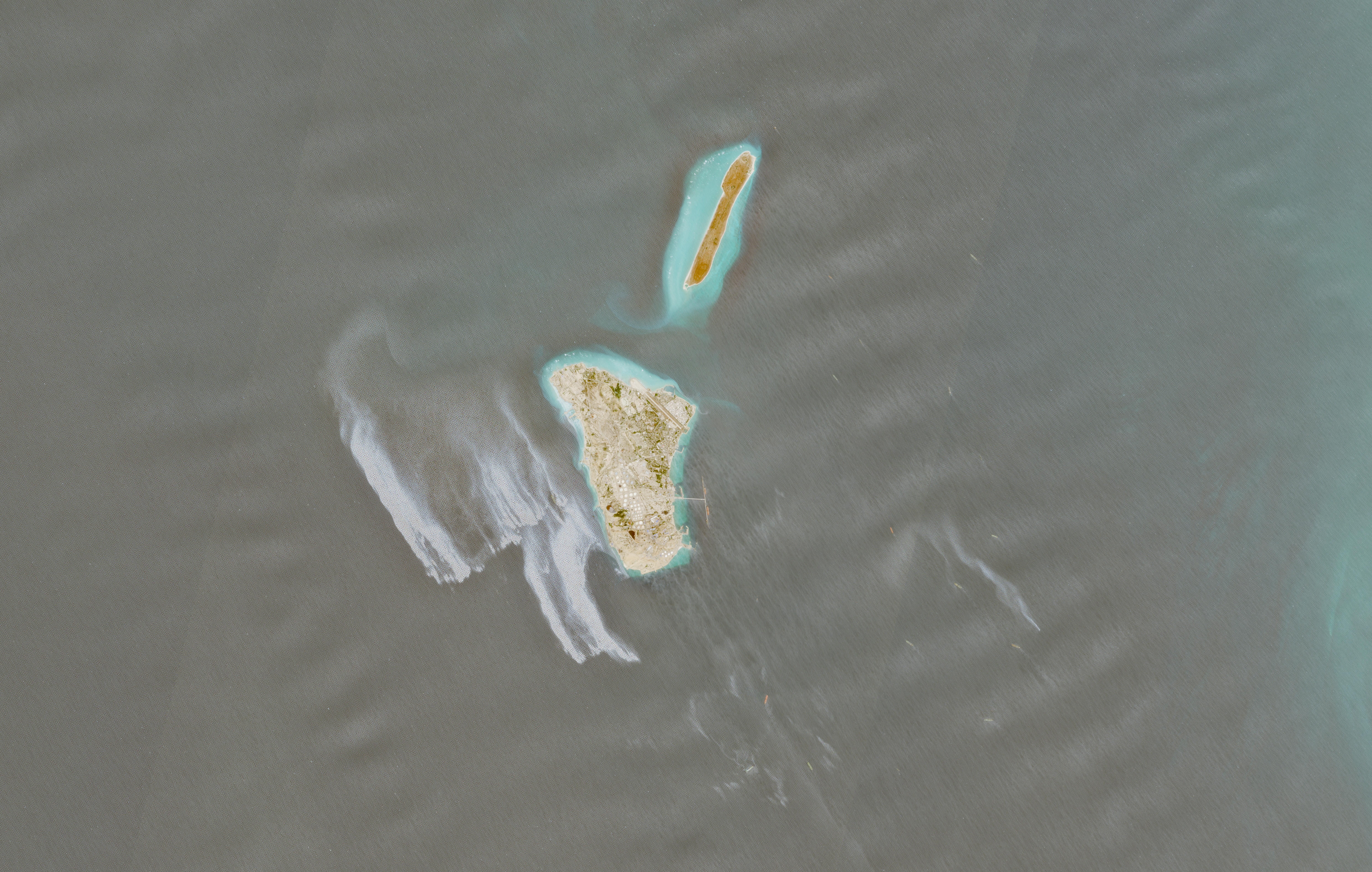 A satellite image shows an oil spill in the sea.