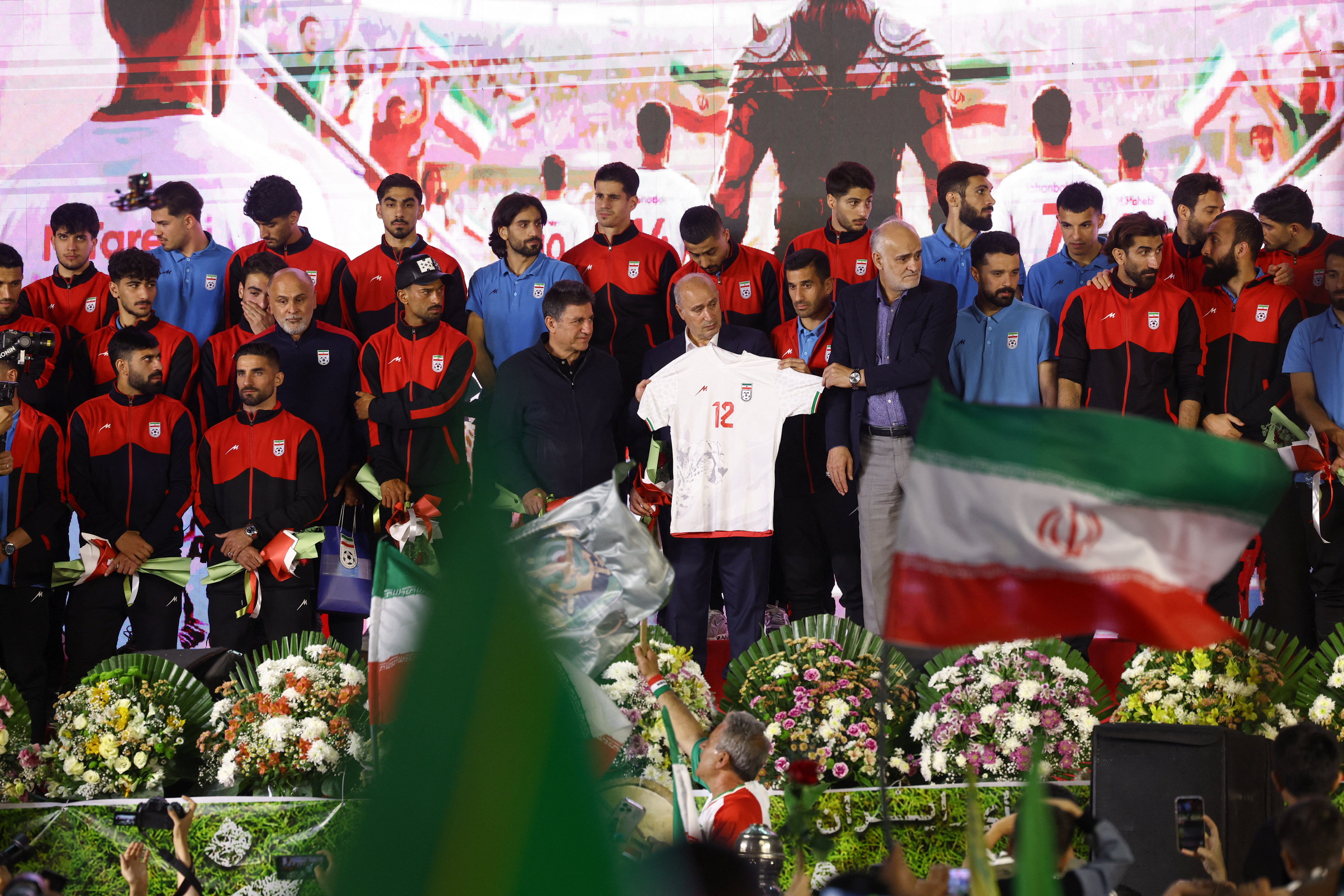 Iran's national soccer team head coach Amir Ghalenoei, Iran Football Federation President Mehdi Taj, and Vice President Mehdi Mohammad Nabi hold a jersey during a team's farewell ceremony ahead of their departure to the 2026 World Cup