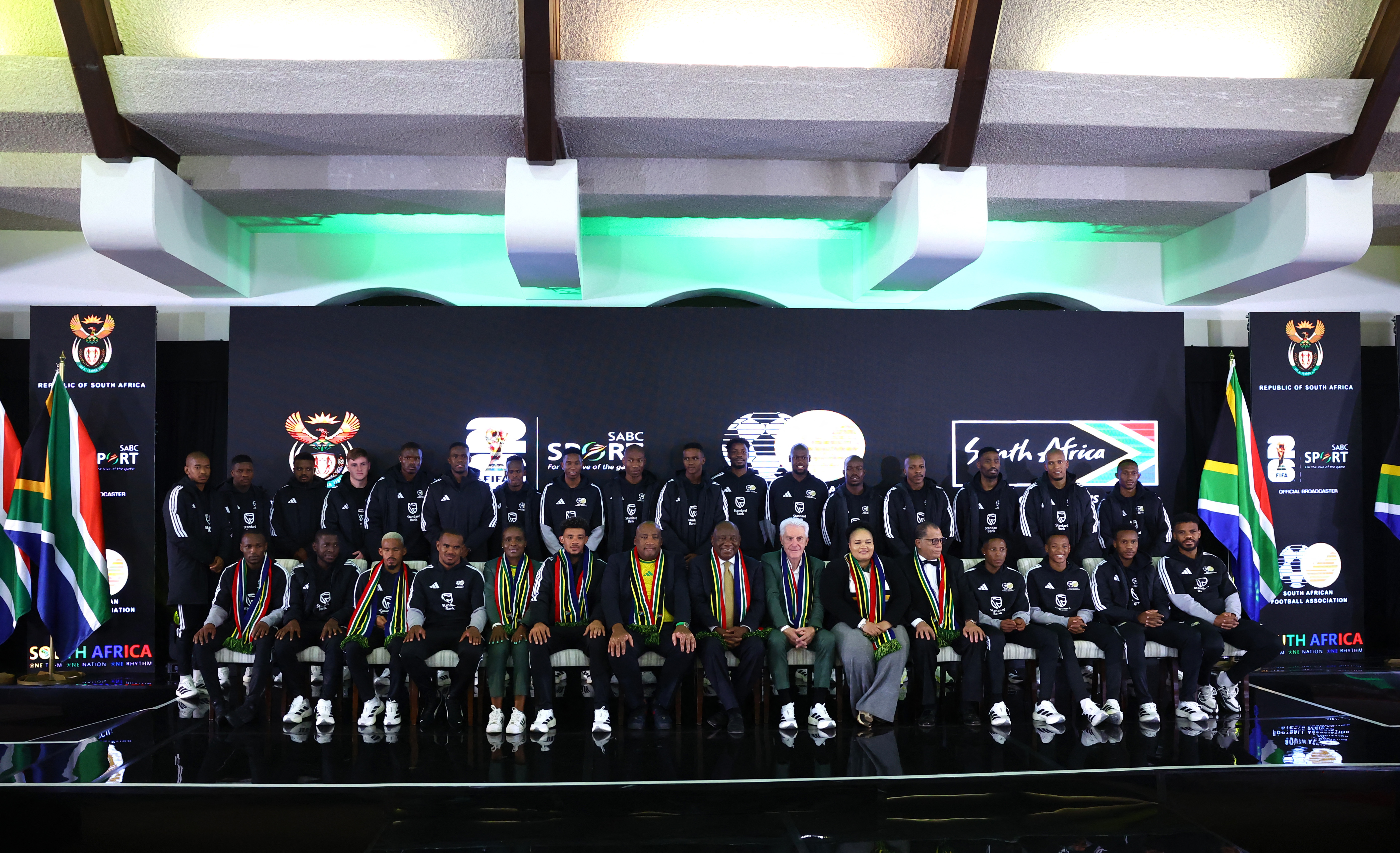 Soccer Football -FIFA World Cup 2026 - South Africa coach Hugo Broos announces his World Cup squad - Sefako Makgatho Presidential Guest House, Pretoria, South Africa - May 27, 2026 South Africa coach Hugo Broos, South Africa president Cyril Ramaphosa and South African football association president Danny Jordaan with the squad during the announcement REUTERS/Siphiwe Sibeko