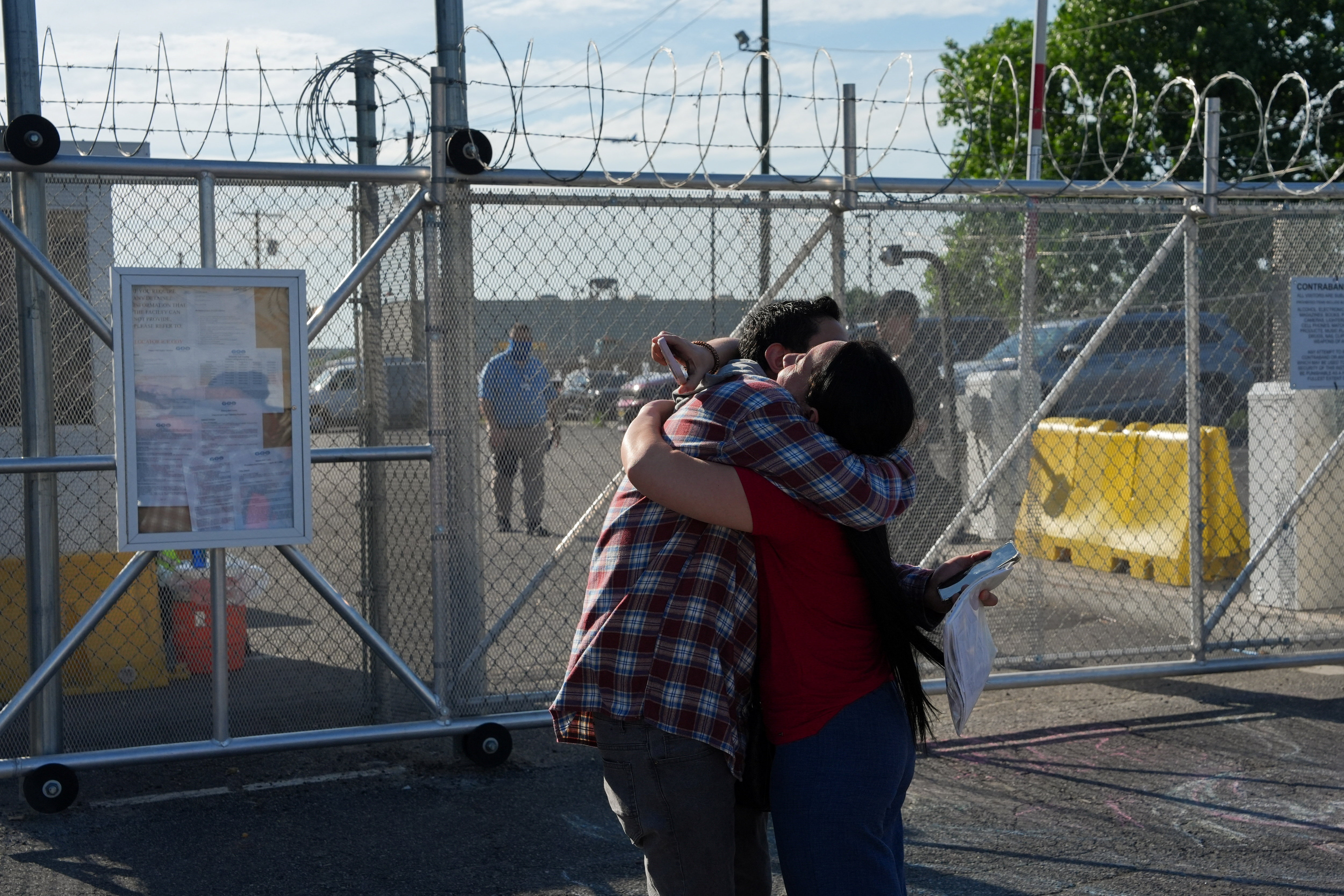 a couple embrace after a person is released from an immigrant detention centre