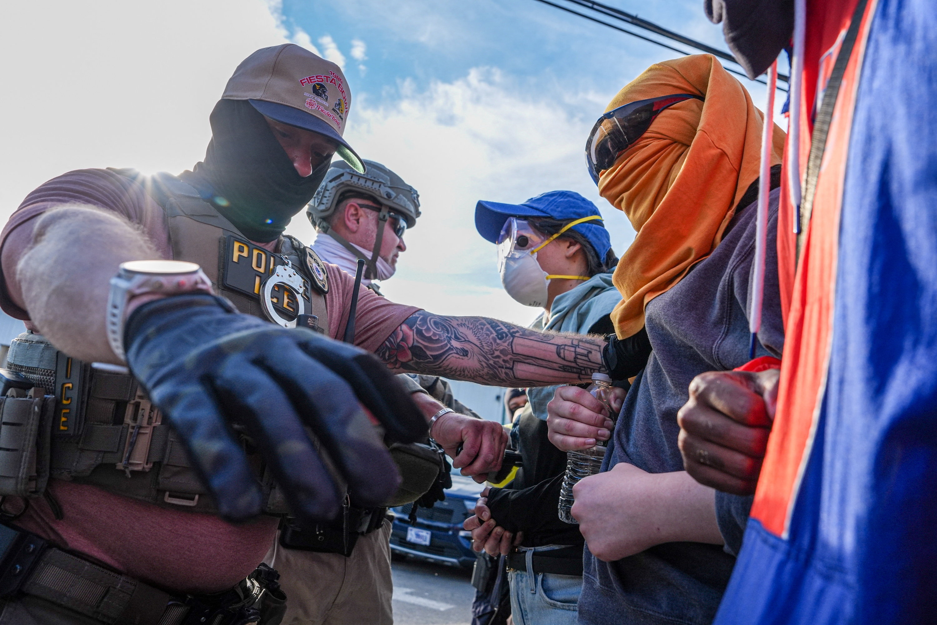 Protesters face a federal agent