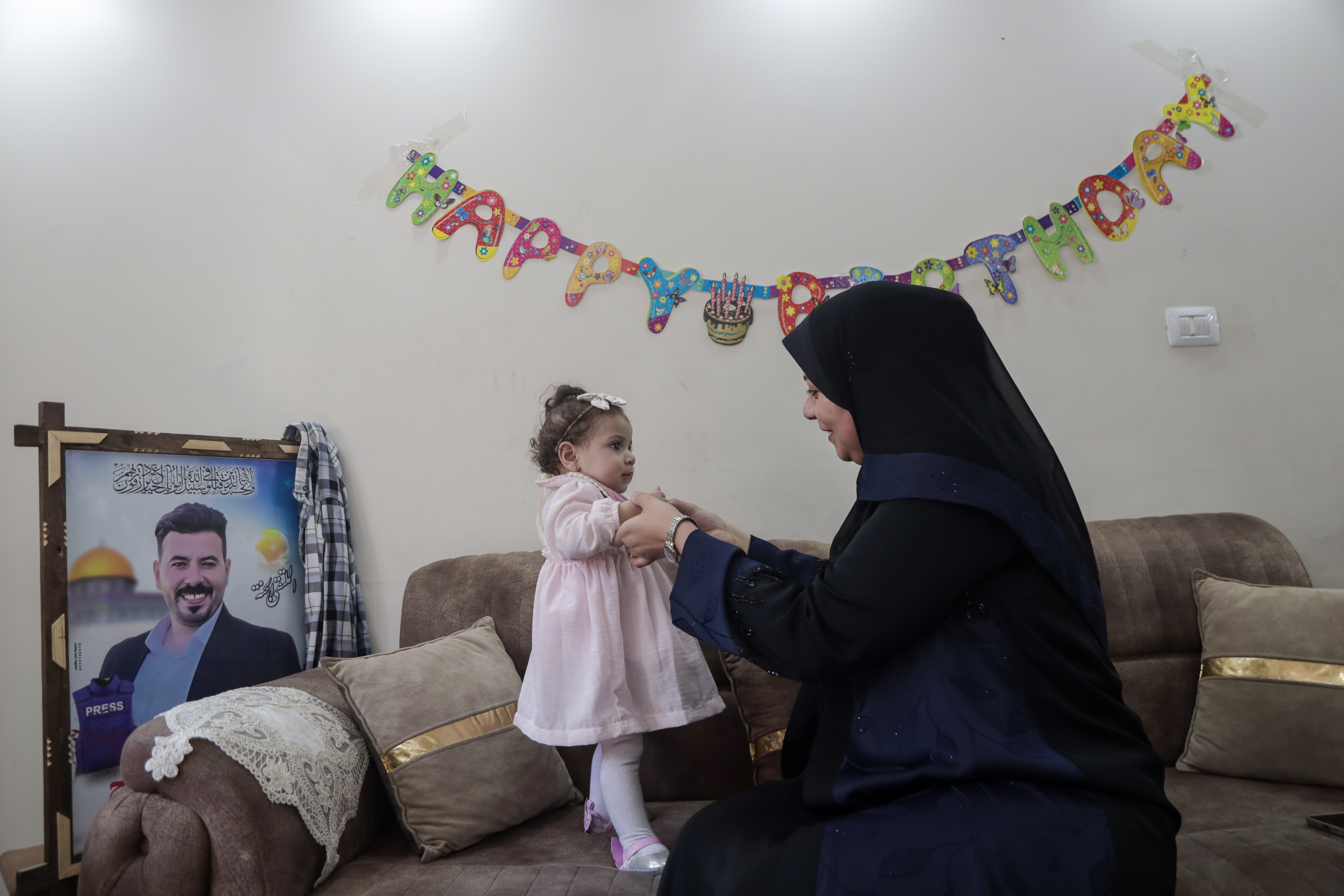 The mother, Amal Sbeih, did not expect to lose her husband during the war on Gaza, and she is now taking on both the father’s and mother’s roles for her three children [Abdelhakim Abu Riash/ Al Jazeera]
