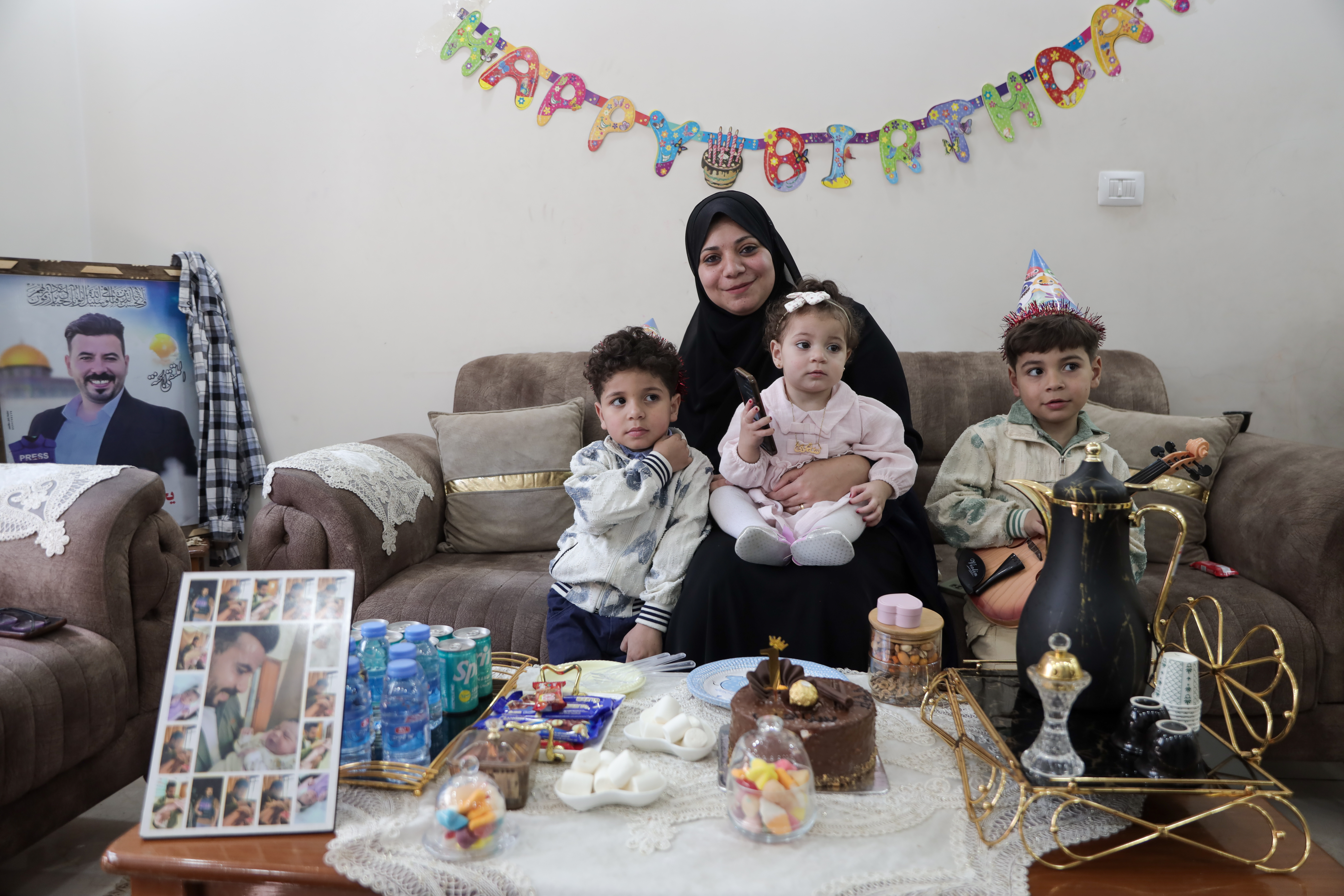 The family decided to celebrate Sana’s first birthday despite the deep grief over the loss of the father on the same date [Abdelhakim Abu Riash/Al Jazeera]