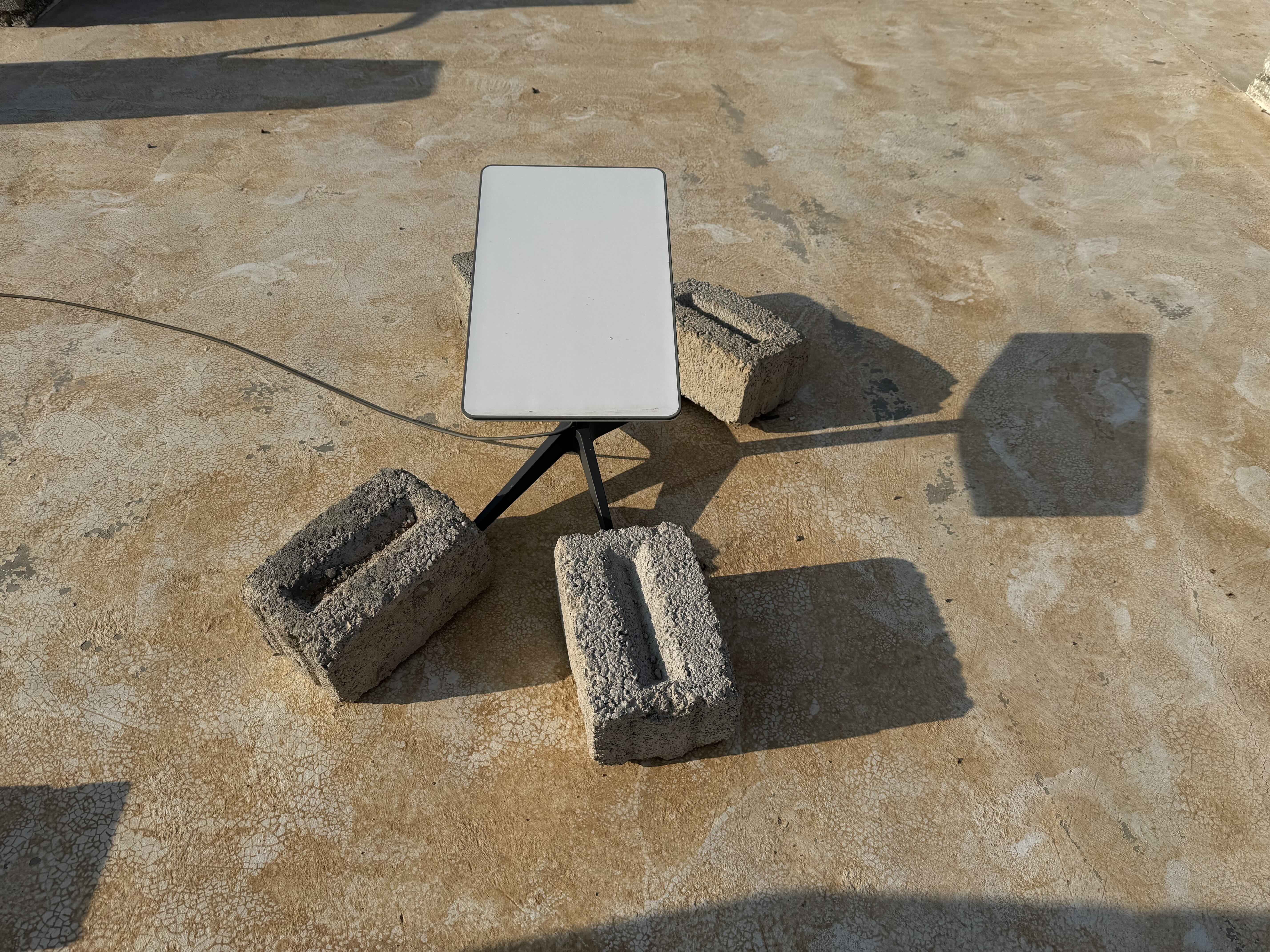 A starlink dish kept in place with bricks