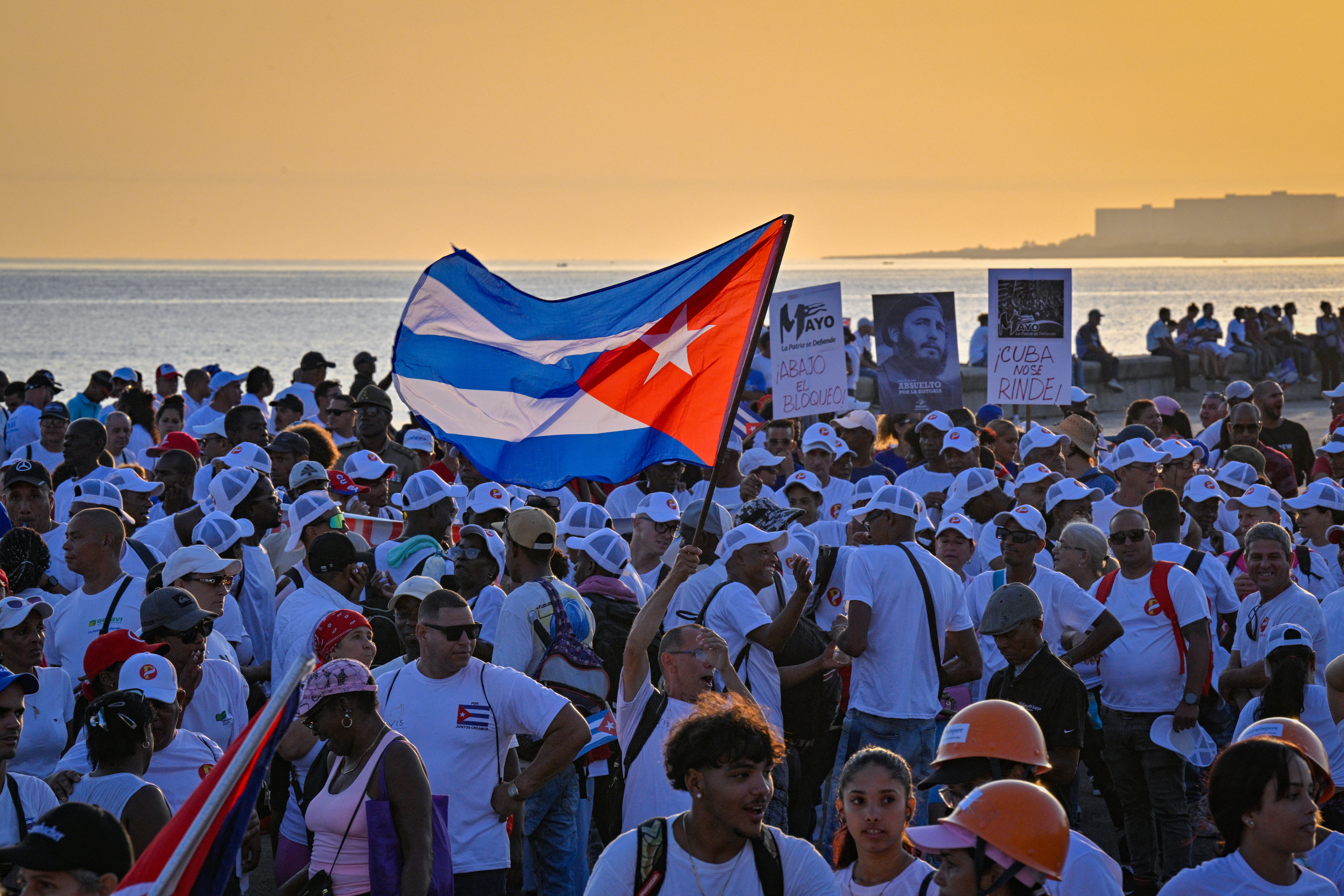 Marchers hold the Cuban flag