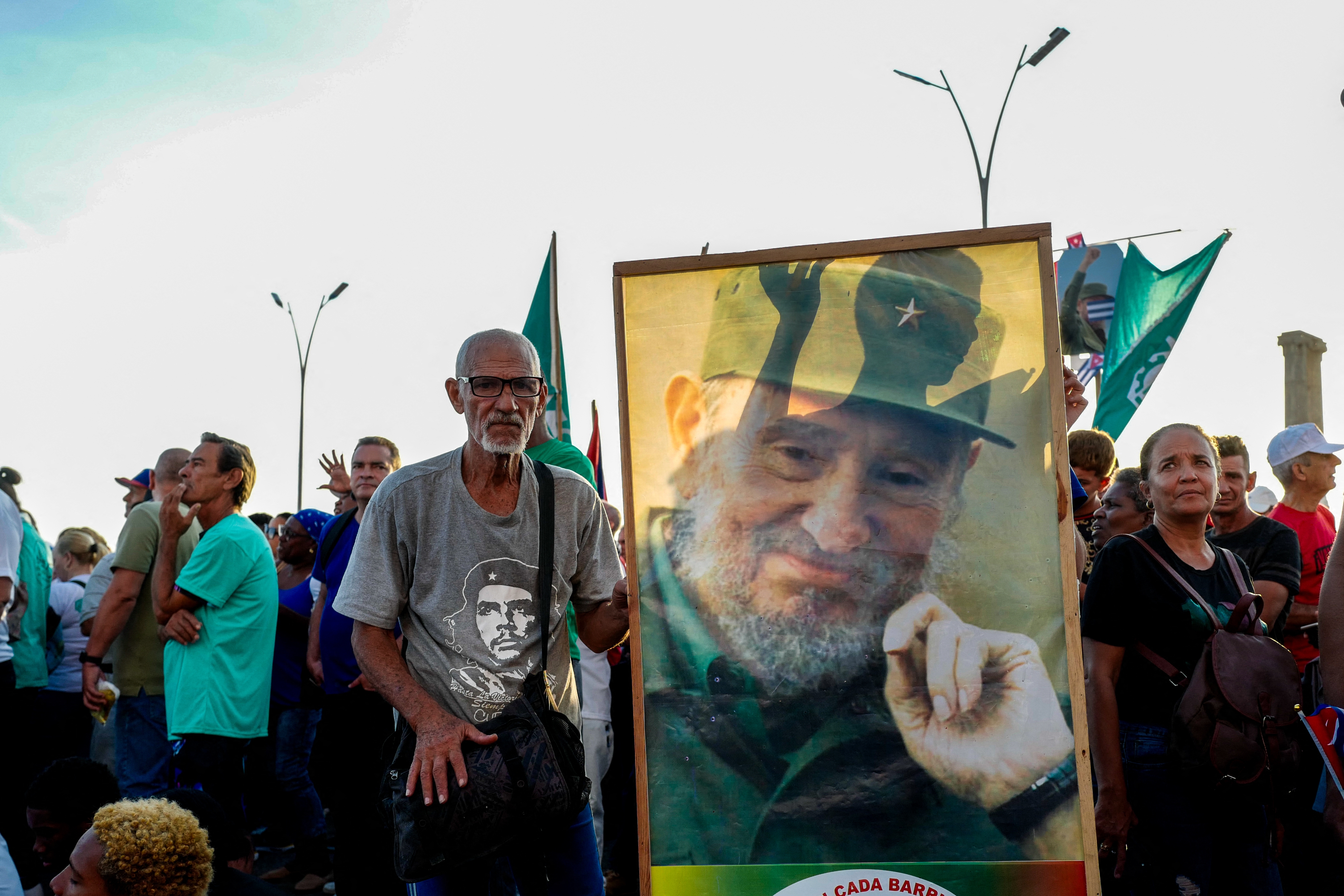 A man with a poster of former Cuban leader Fidel Castro