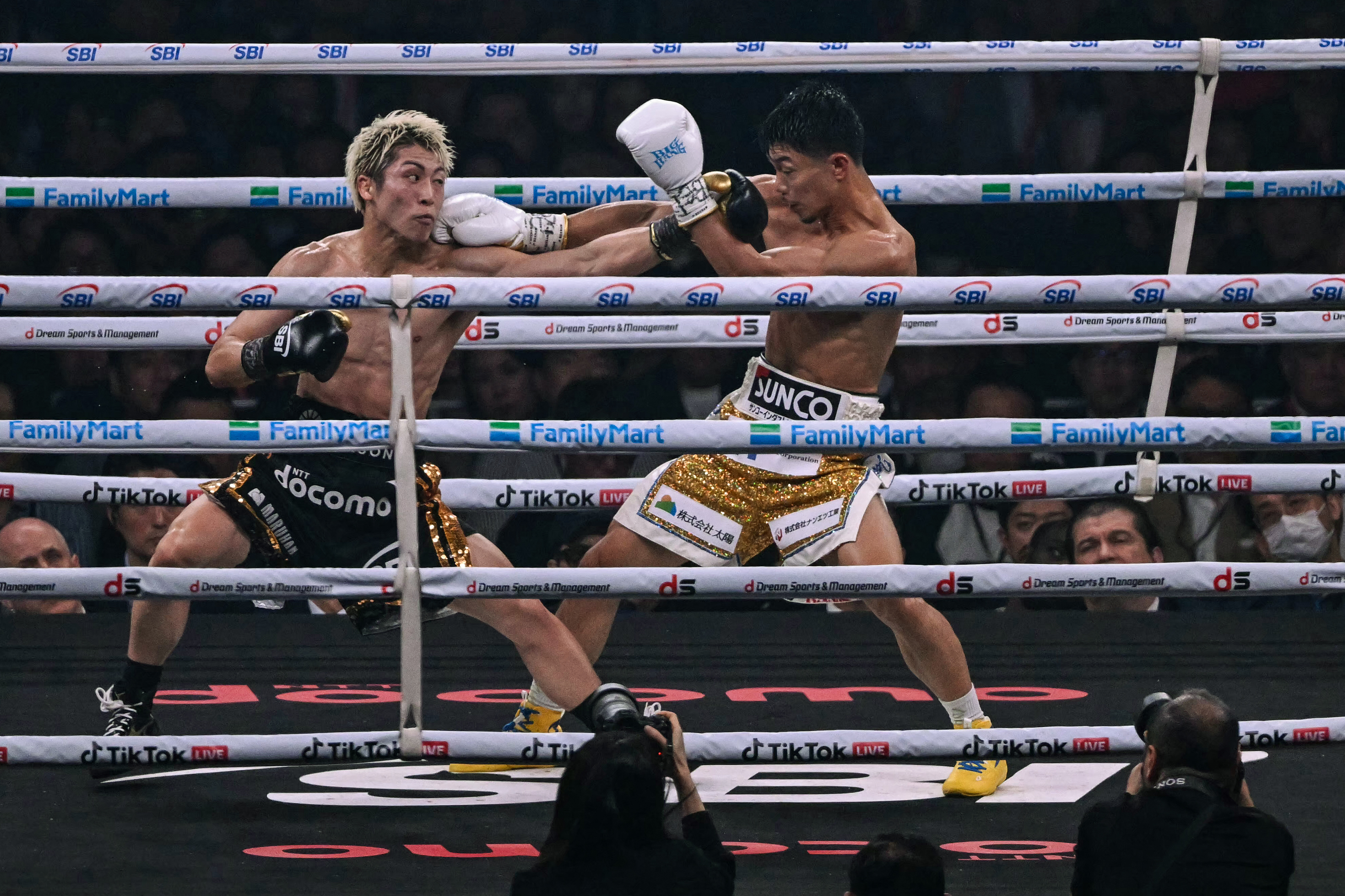 Naoya Inoue (L) fights Junto Nakatani during their super bantamweight championship boxing contest at Tokyo Dome in Tokyo on May 2, 2026. (Photo by Yuichi YAMAZAKI / AFP)