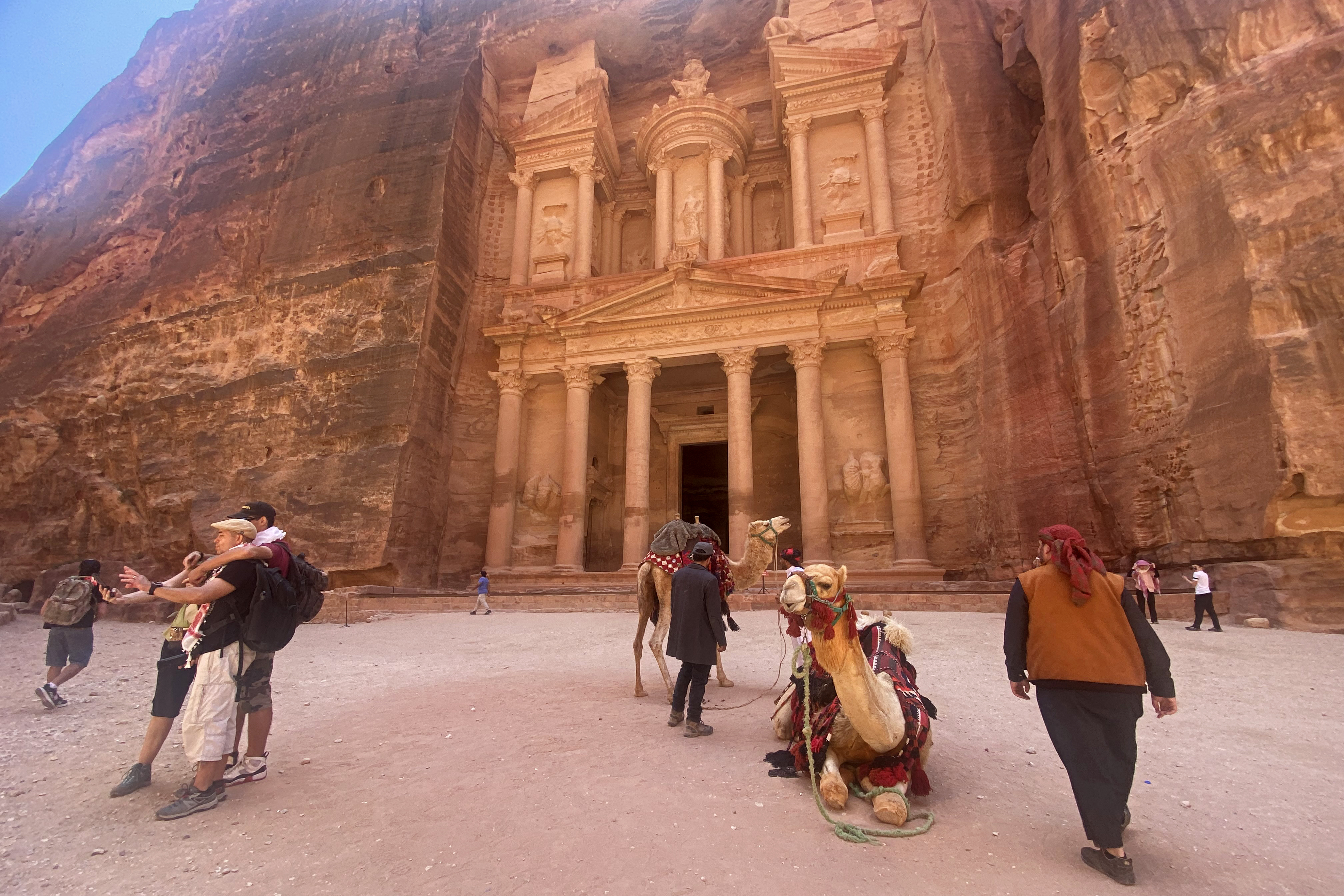 Tourists visit the Treasury in the ruins of the ancient Nabatean city of Petra