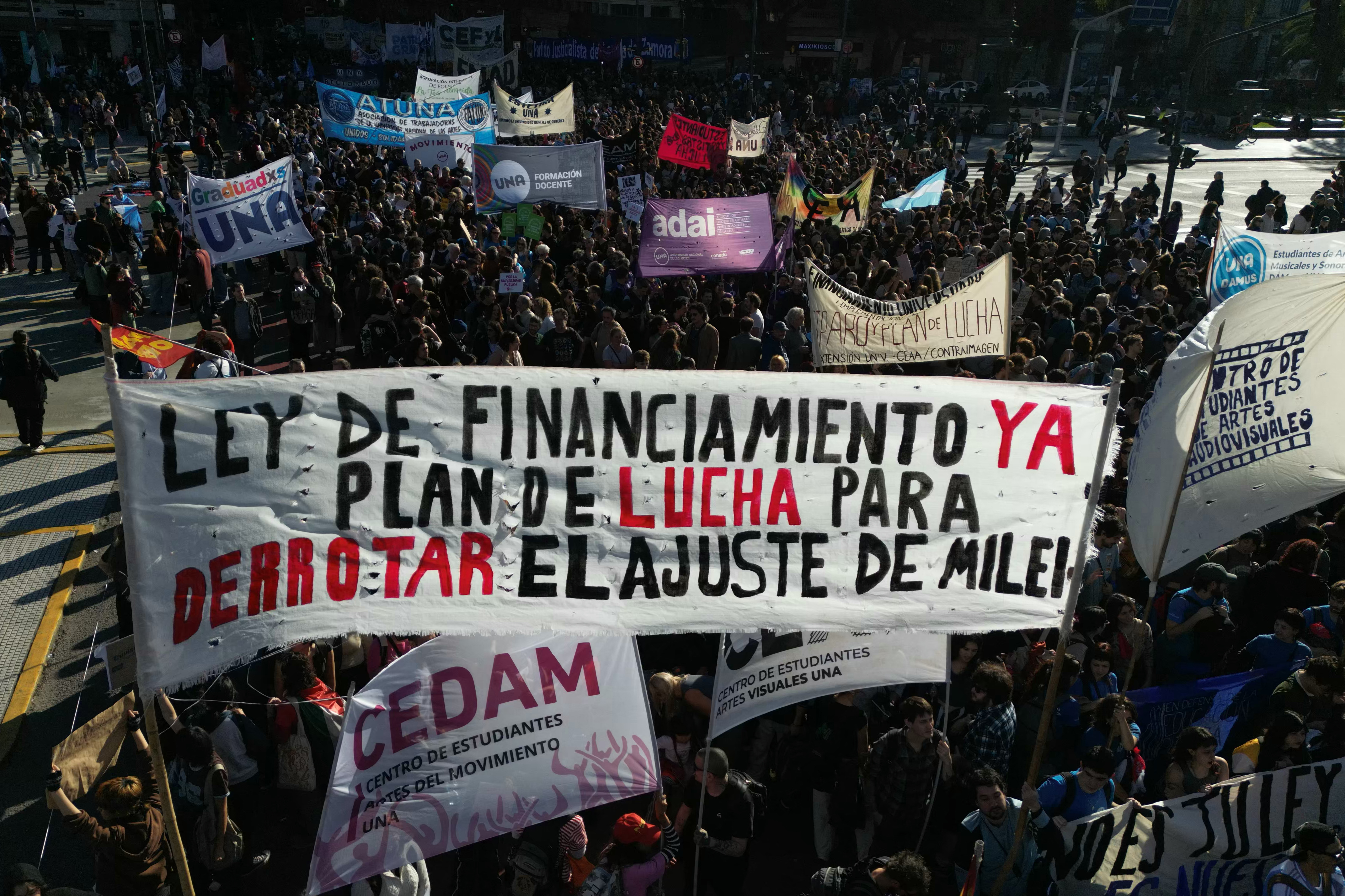 Protesters hold banners.