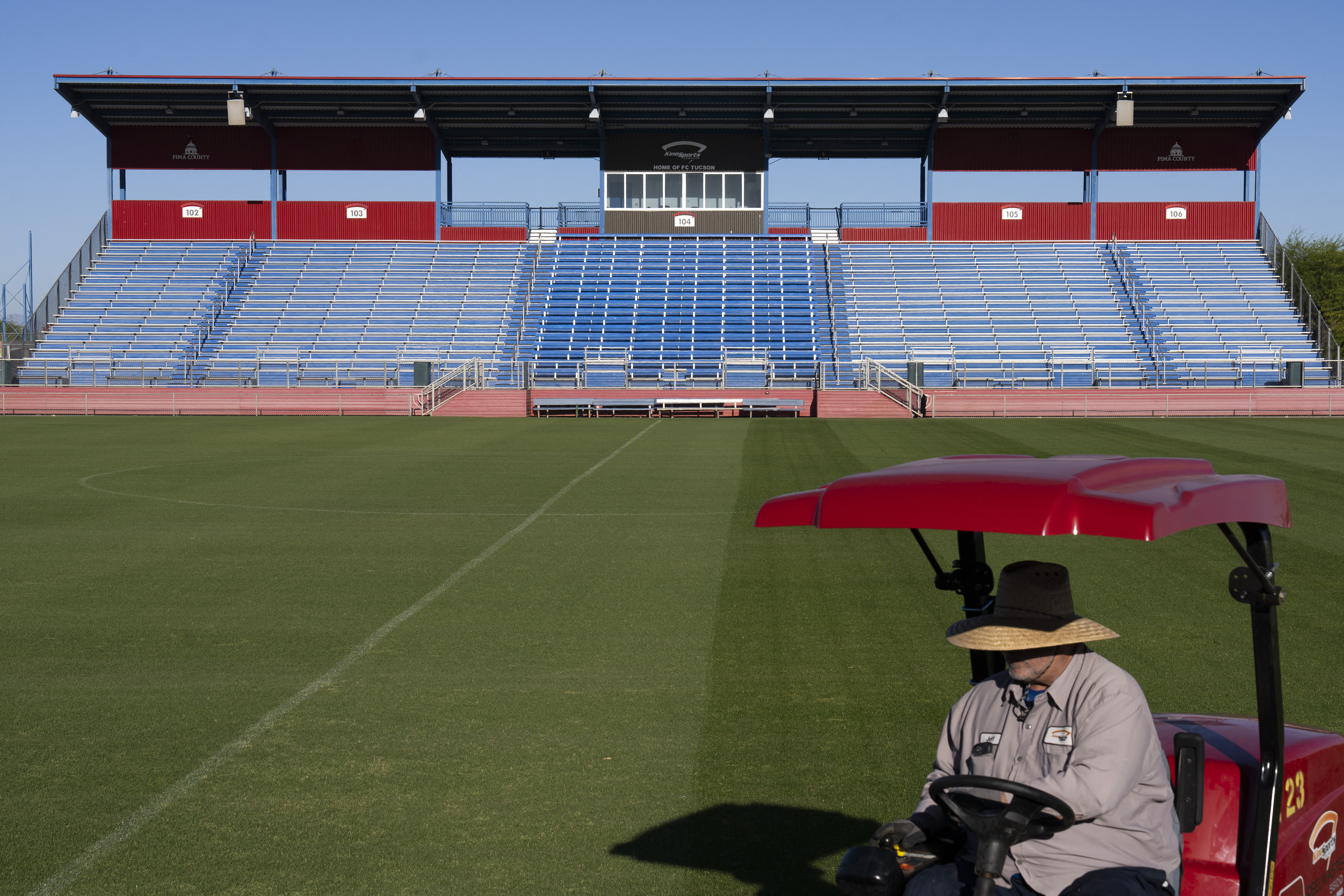 A worker cuts the grass at the Kino Sports Complex, where Iran's national football team Team Melli will train during the 2026 FIFA World Cup, in Tucson, Arizona, on May 7, 2026. In the Strait of Hormuz, US warships menace Iran's oil tankers. In Washington, President Donald Trump threatens nothing less than "complete victory" will suffice. But in Tucson, they're getting ready to welcome the Iranian football team as if nothing were amiss. The city, an oasis of manicured lawns in the Arizona desert, is set to be the base camp for "Team Melli" when the world's biggest sporting spectacle opens in the US, Mexico and Canada next month. (Photo by Rebecca NOBLE / AFP)