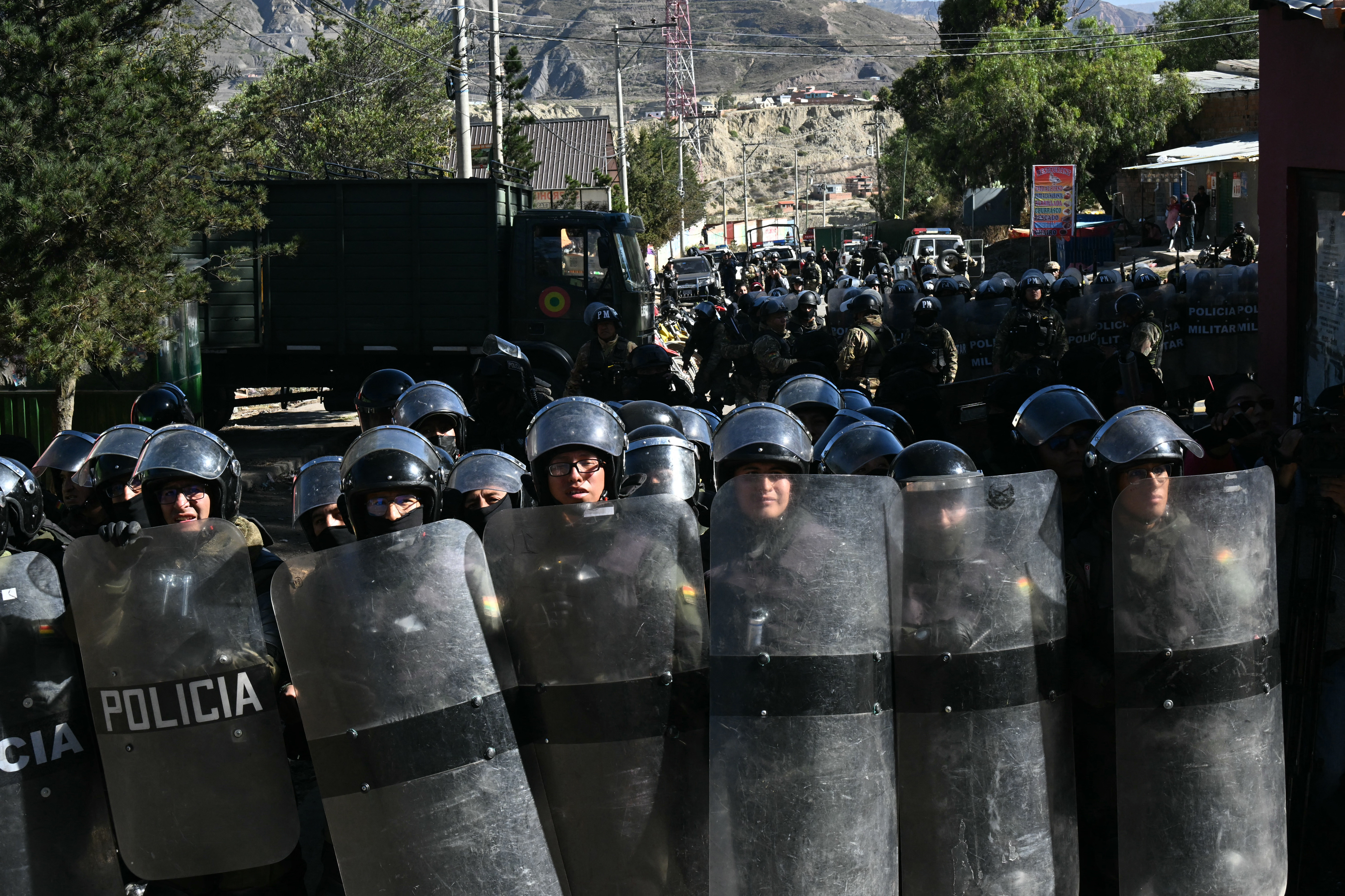 Riot police officers stand guard during clashes with rural protesters in Lipari, La Paz