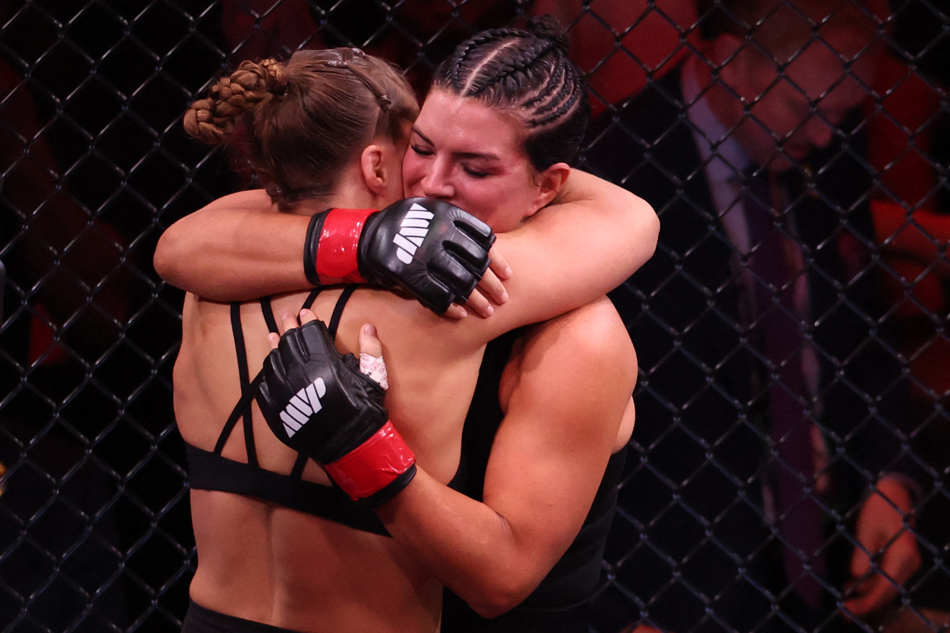 Ronda Rousey and Gina Carano share an emotional embrace after their fight in California, US