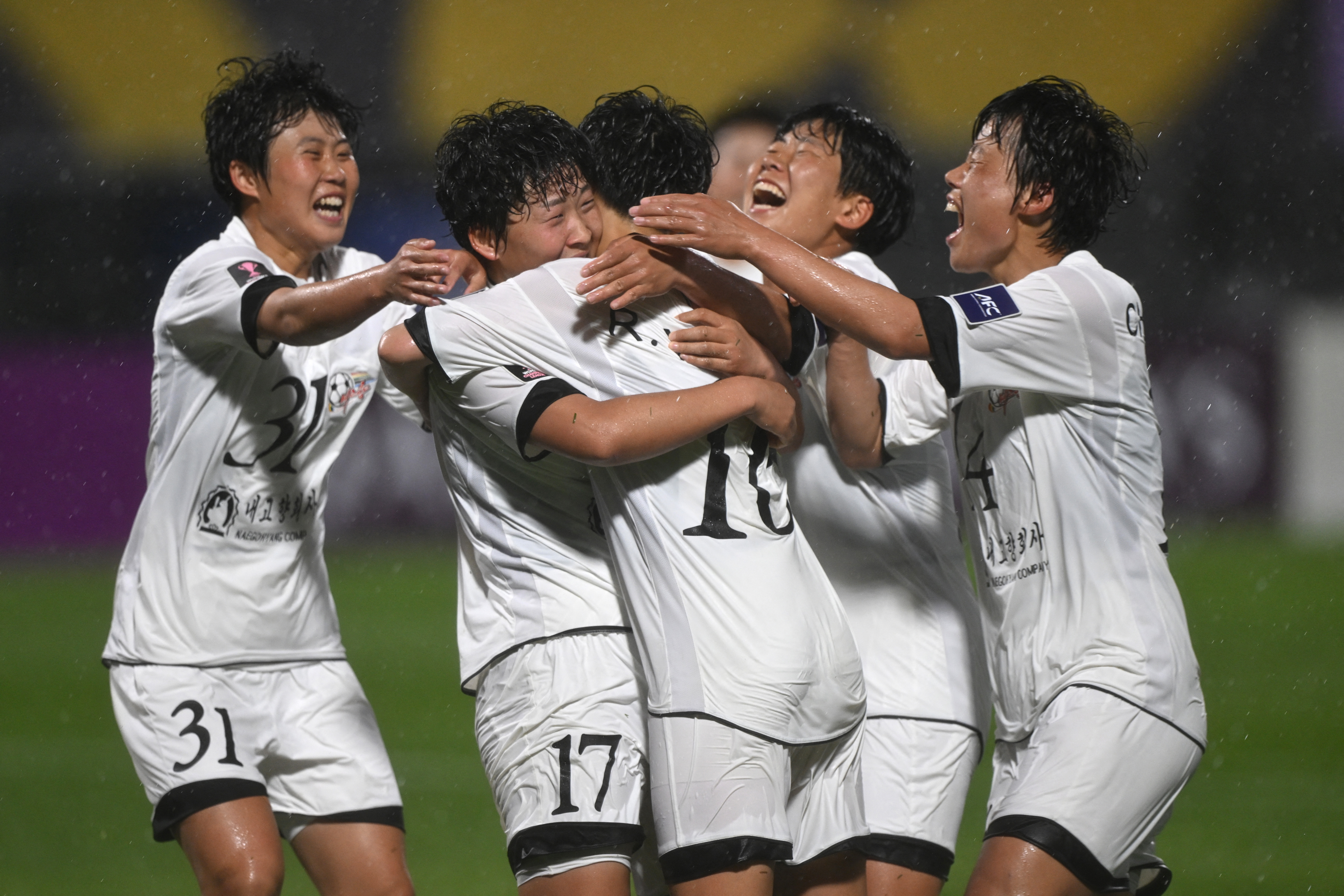 Kim Kyong Yong (2nd L #17) of Naegohyang Women's FC celebrates scoring her team's second goal with teammates during the AFC Women's Champions League semi-final football match between North Korea's Naegohyang Women's FC and South Korea's Suwon FC Women in Suwon on May 20, 2026. (Photo by Jung Yeon-je / AFP)