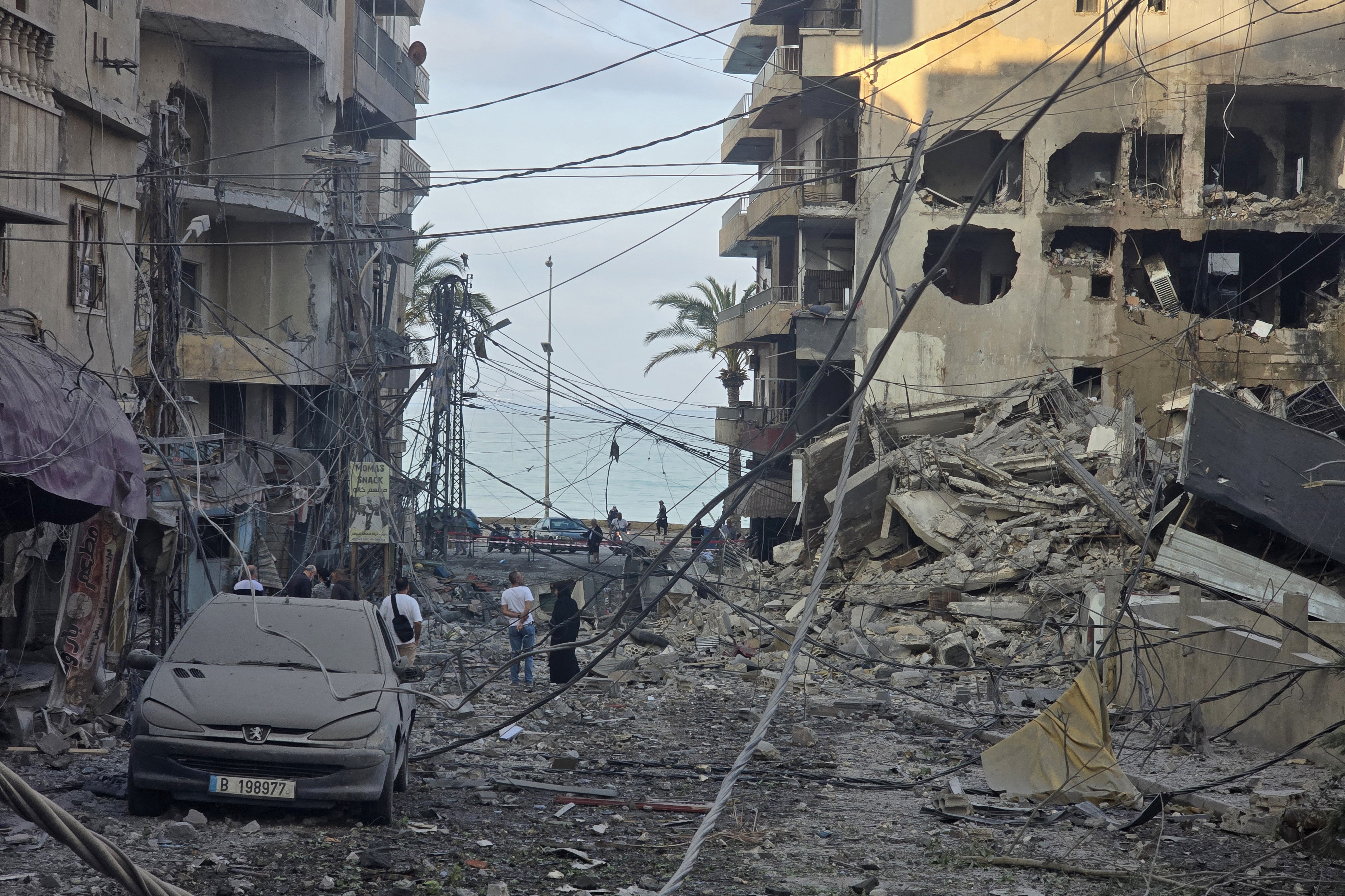 People inspect the site of an Israeli attack.