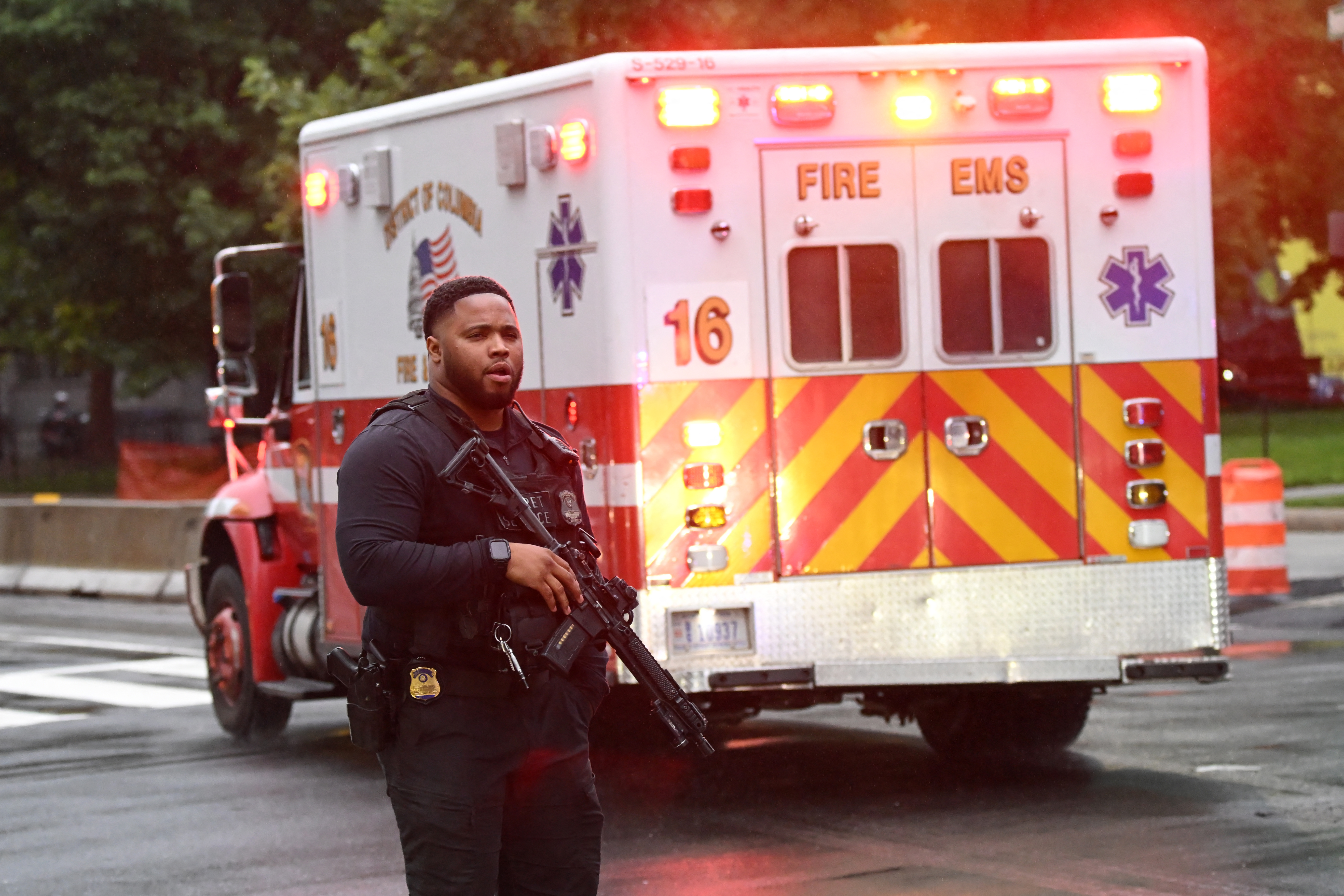 An armed Secret Service agent is seen next to an ambulance near the White House in Washington, DC, on May 23, 2026.