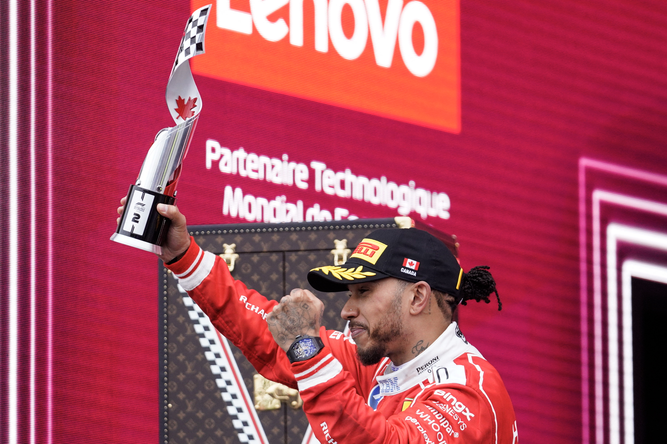 Ferrari's British driver Lewis Hamilton holds his second place trophy as he celebrates on the podium at the conclusion of the 2026 Formula 1 Grand Prix du Canada at Circuit Gilles-Villeneuve in Montreal, Canada, on May 24, 2026. (Photo by Geoff Robins / AFP)