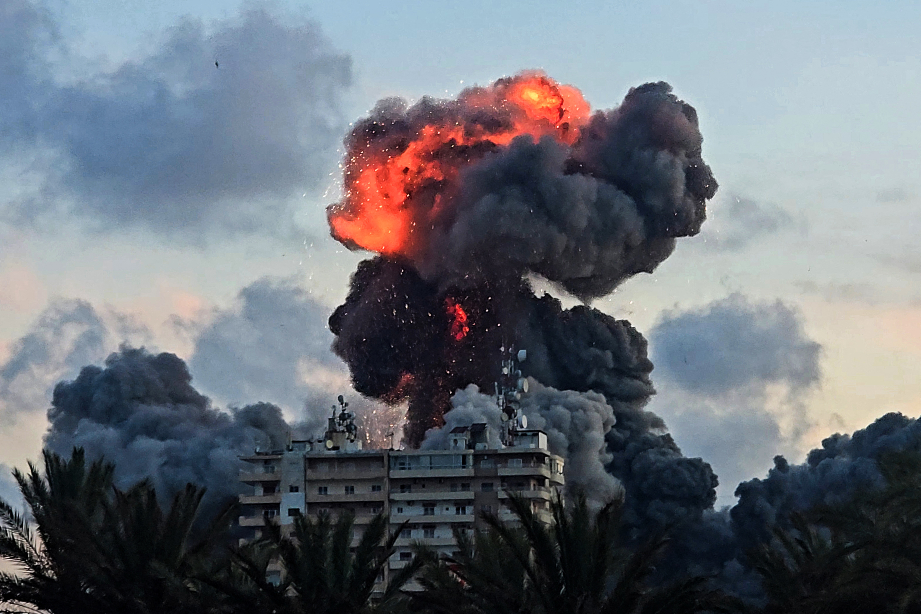 A fireball and smoke erupt from a building following an Israeli strike in Tyre, southern Lebanon,