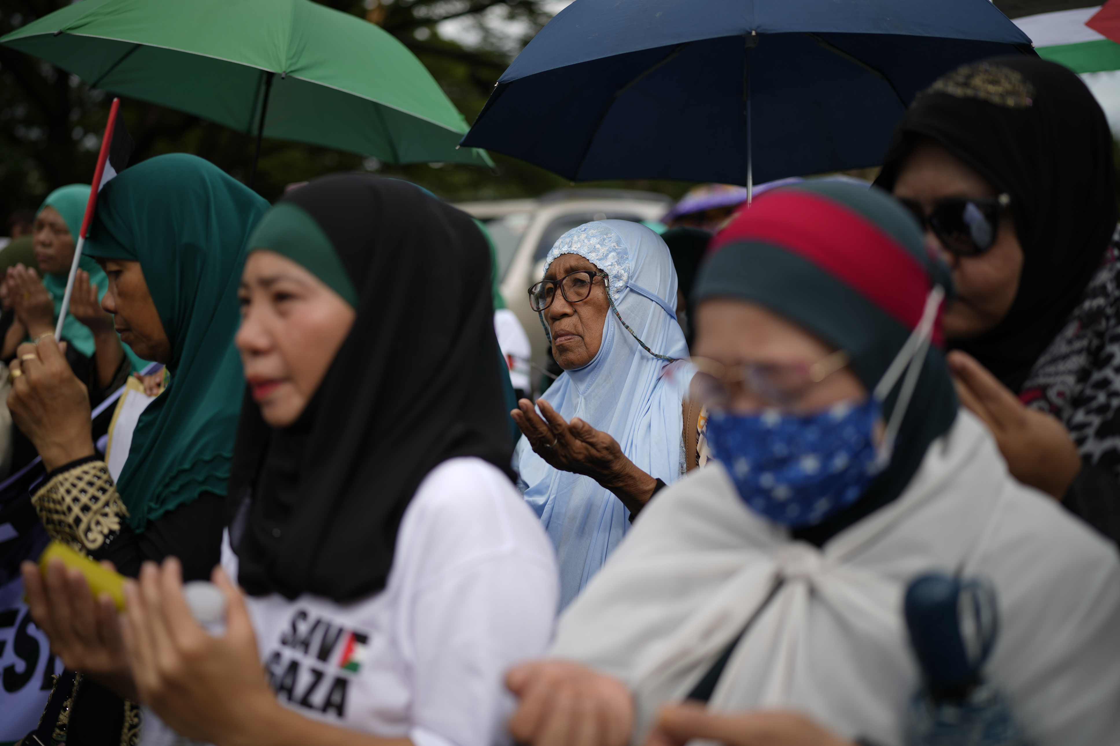 Filipino Muslims pray during a demonstration in support of the Palestinian people and calling for a ceasefire in Gaza outside the Blue Mosque in Taguig, Philippines on Friday, Nov. 24, 2023. (AP Photo/Aaron Favila)