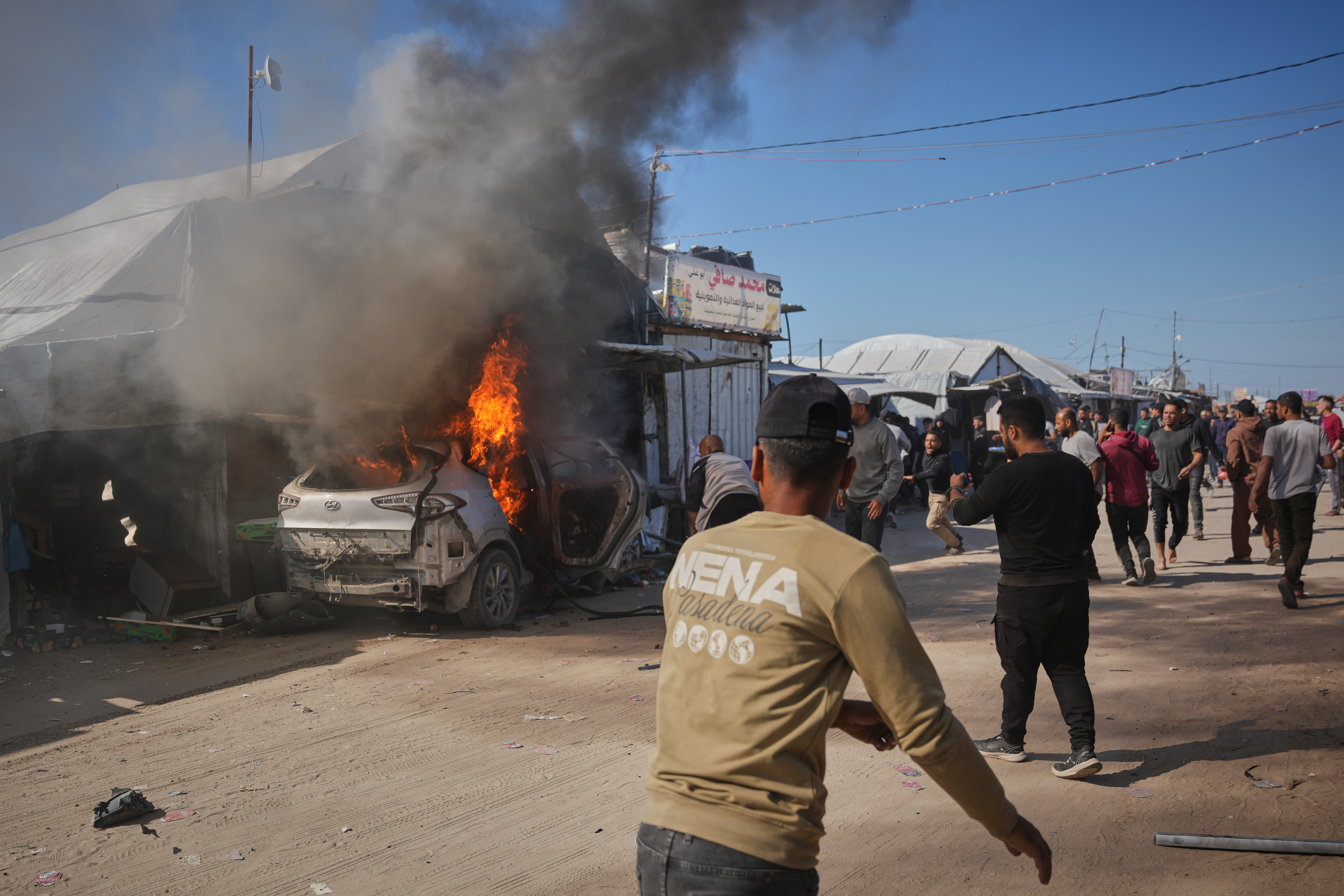 Palestinians gather around a vehicle struck by an Israeli air strike in Khan Younis, southern Gaza on May 6, 2026.