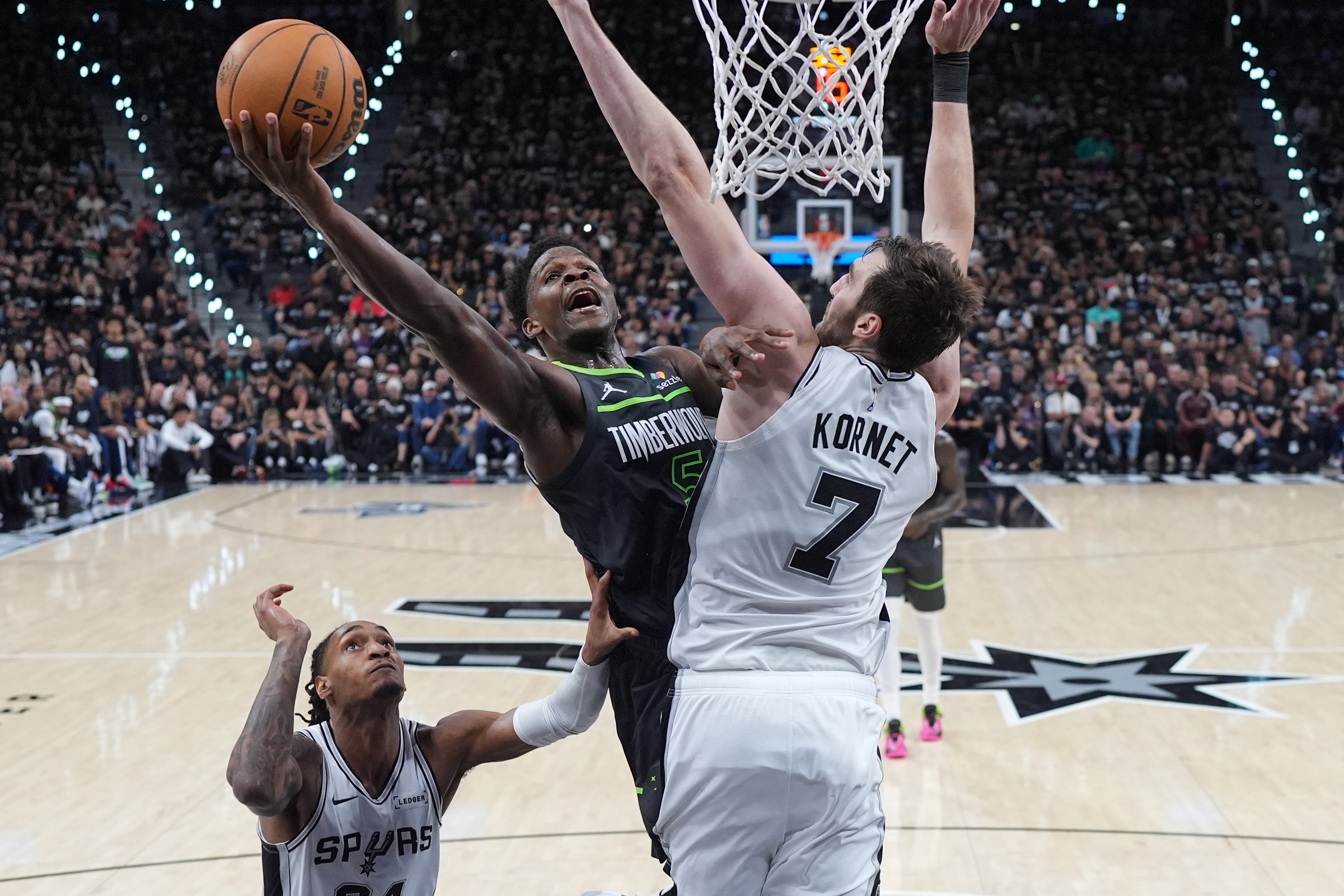 Minnesota Timberwolves guard Anthony Edwards (5) drives to the basket aginst San Antonio Spurs center Luke Kornet (7) during the first half in Game 2 of a second-round NBA playoffs basketball series in San Antonio, Wednesday, May 6, 2026. (AP Photo/Eric Gay)