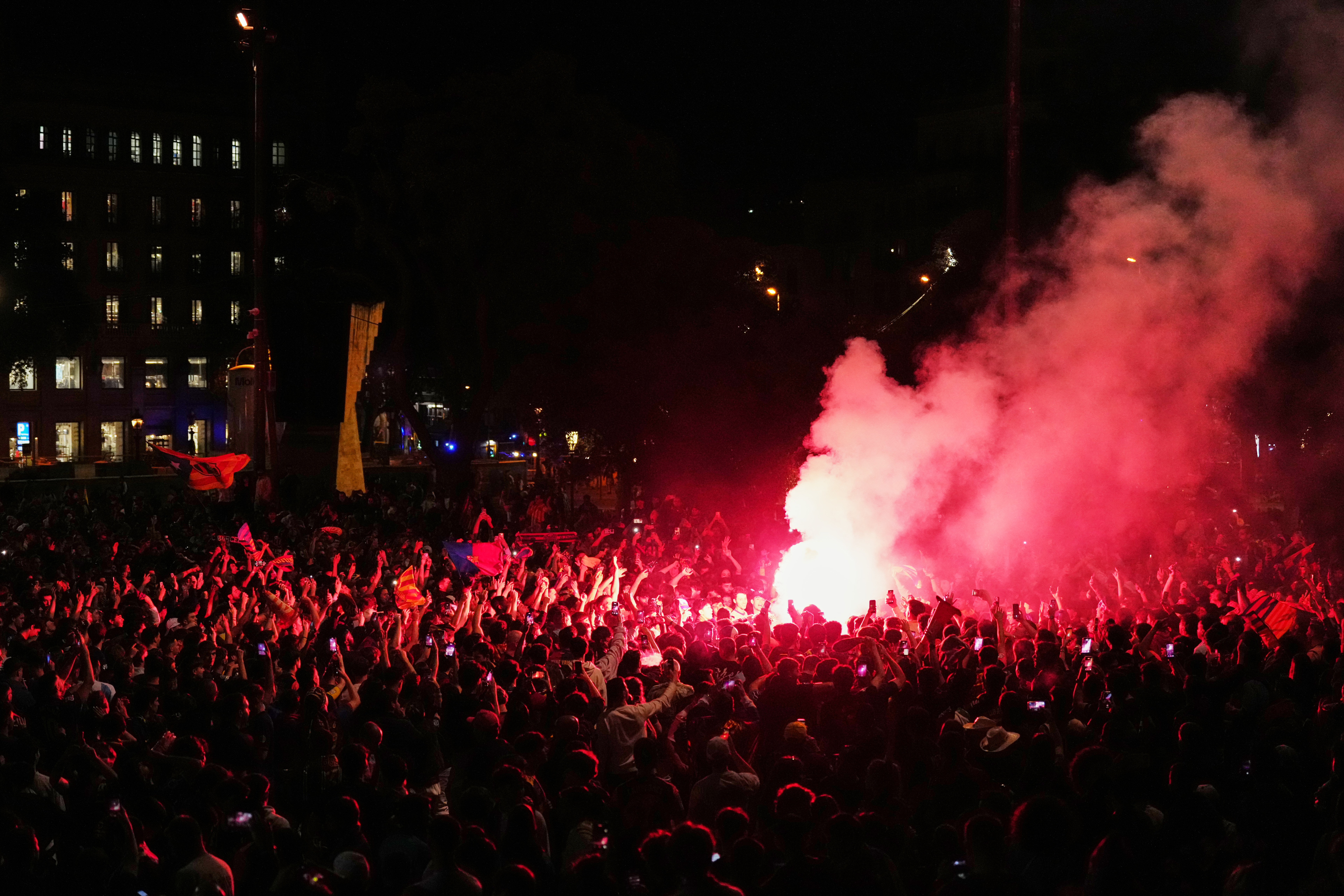 Thousands of Barca fans celebrate at the Placa de Catalunya in central Barcelona after winning the La Liga title on Sunday