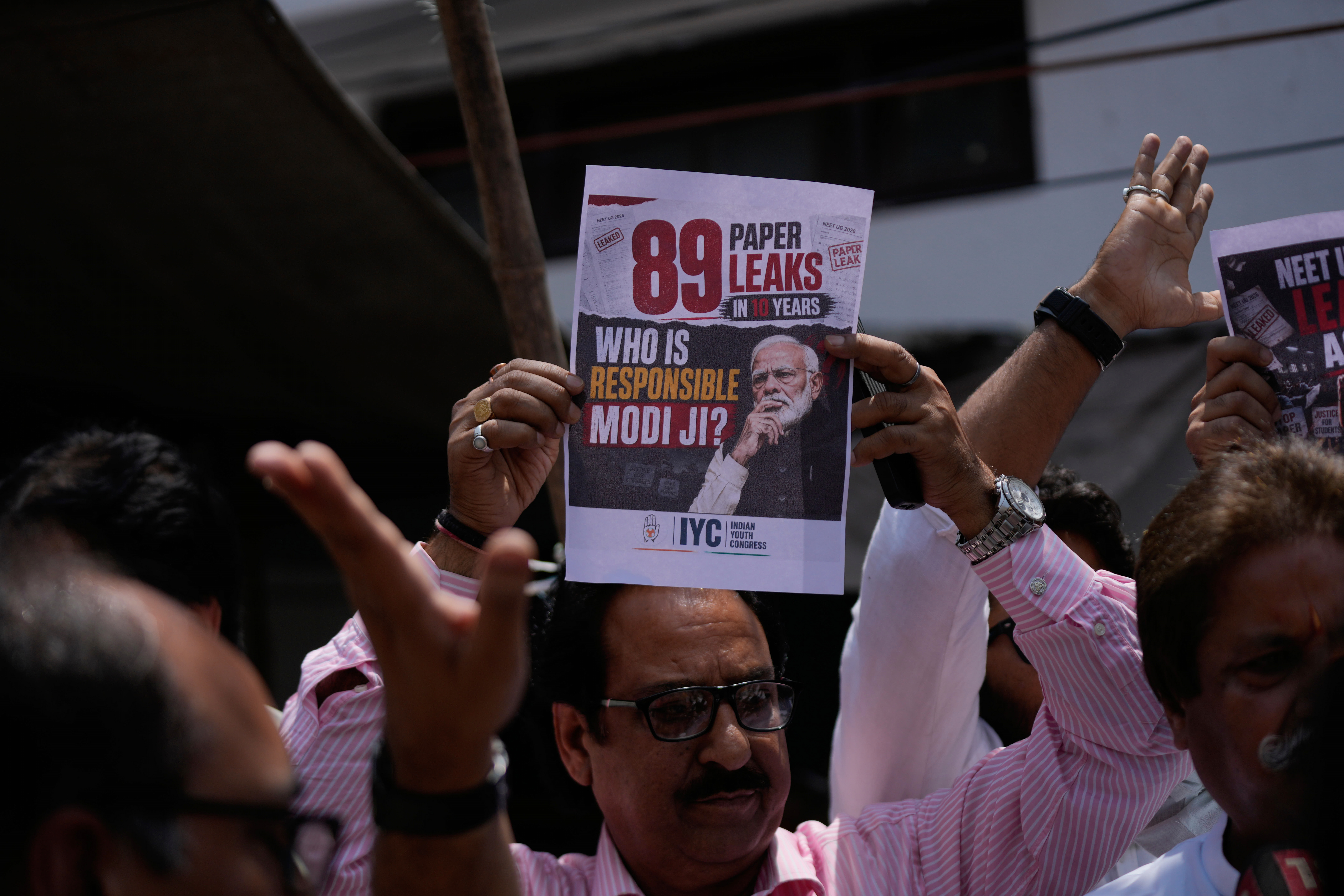 Congress party supporters hold placards during a protest against the central government following the cancellation of the NEET-UG 2026 examination amid allegations of a paper leak and irregularities, in Jammu, India, Wednesday, May 13, 2026.(AP Photo/Channi Anand)