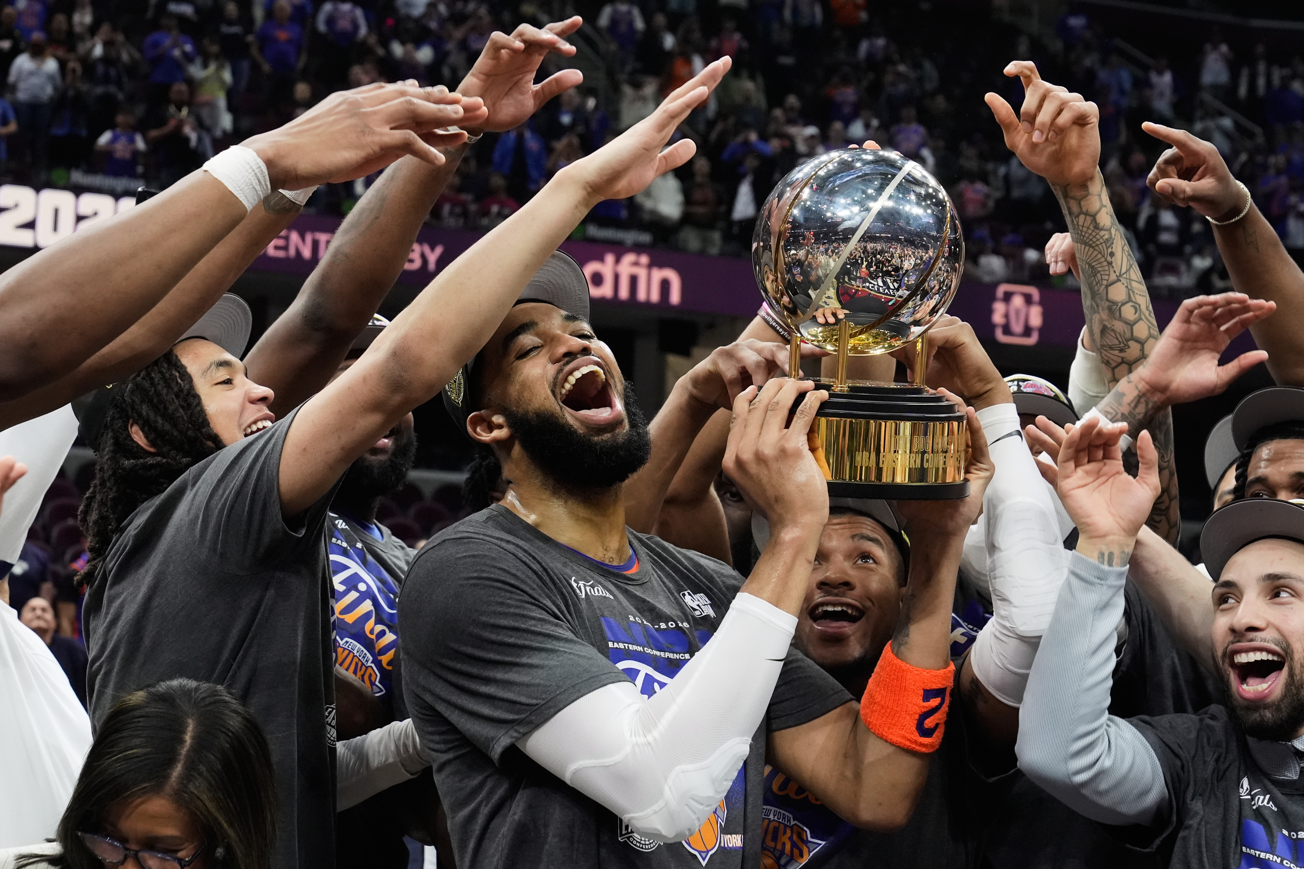 New York Knicks centre Karl-Anthony Towns, centre, and teammates celebrate.