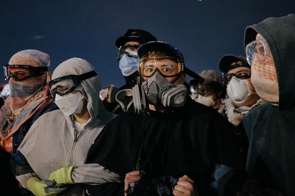 protesters wearing gas masks