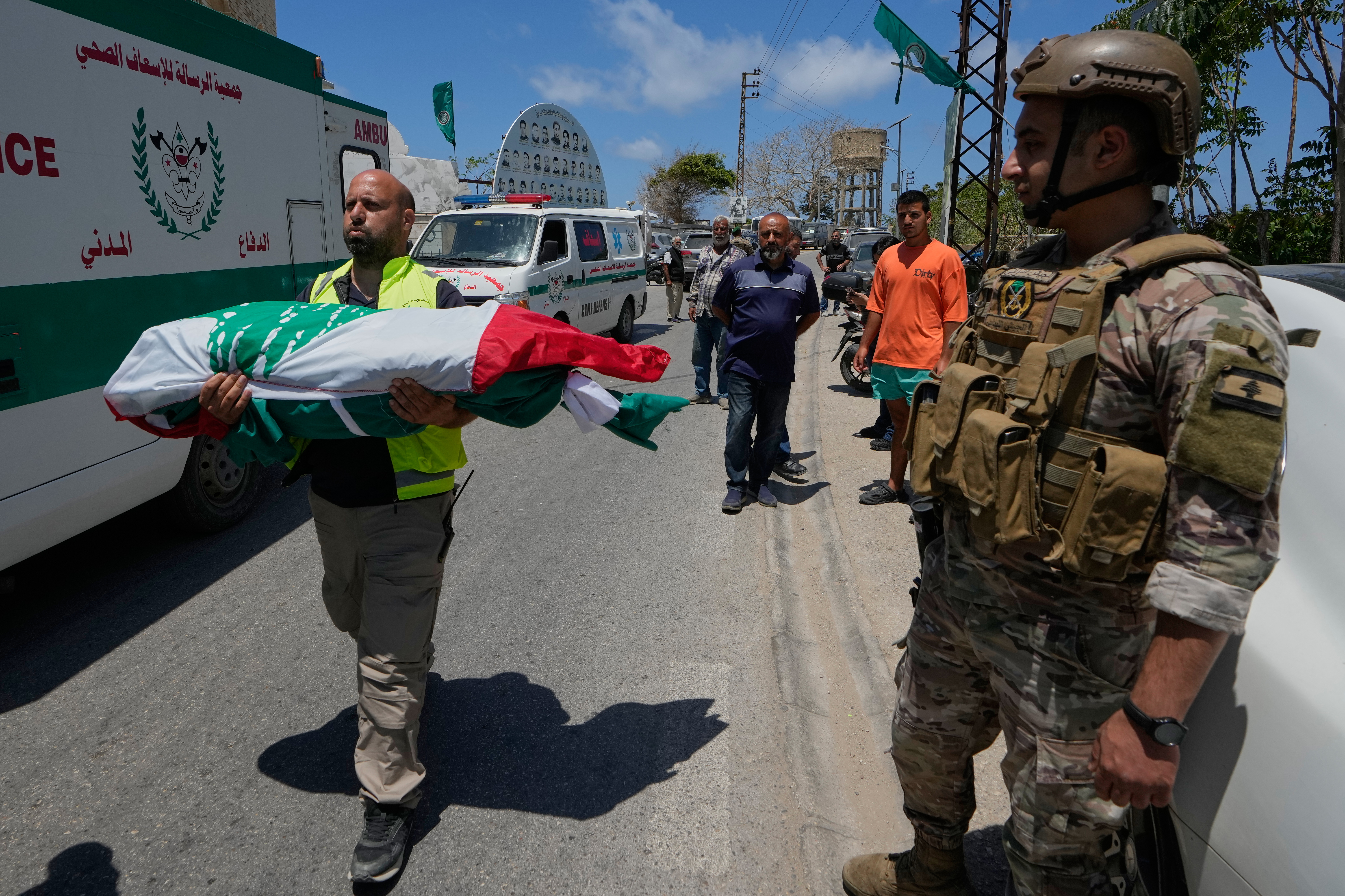 A paramedic volunteer carries a body, one of the six the family members who were killed on Wednesday when their car was struck in an Israeli airstrike on a highway as they fled their village, during a funeral procession in the southern port city of Tyre, Lebanon, Friday, May 29, 2026. (AP