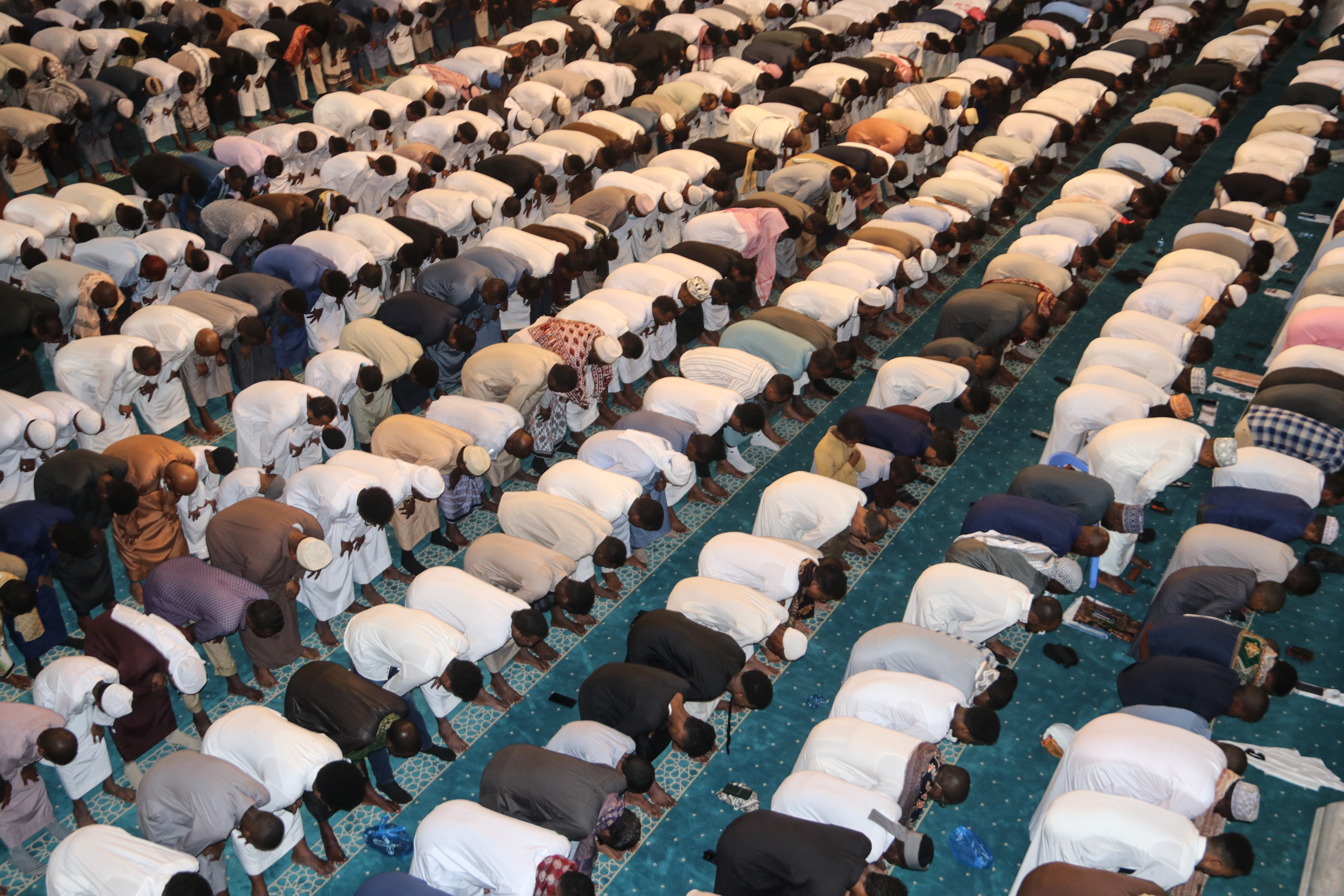 Worshippers perform rukuu (bow) during Eid salah at Ali Jimale Mosque in Mogadishu. The communal prayer is the spiritual centrepiece of Eid celebrations, bringing together the congregants in a shared act of worship. [Faisal Ali/Al Jazeera]