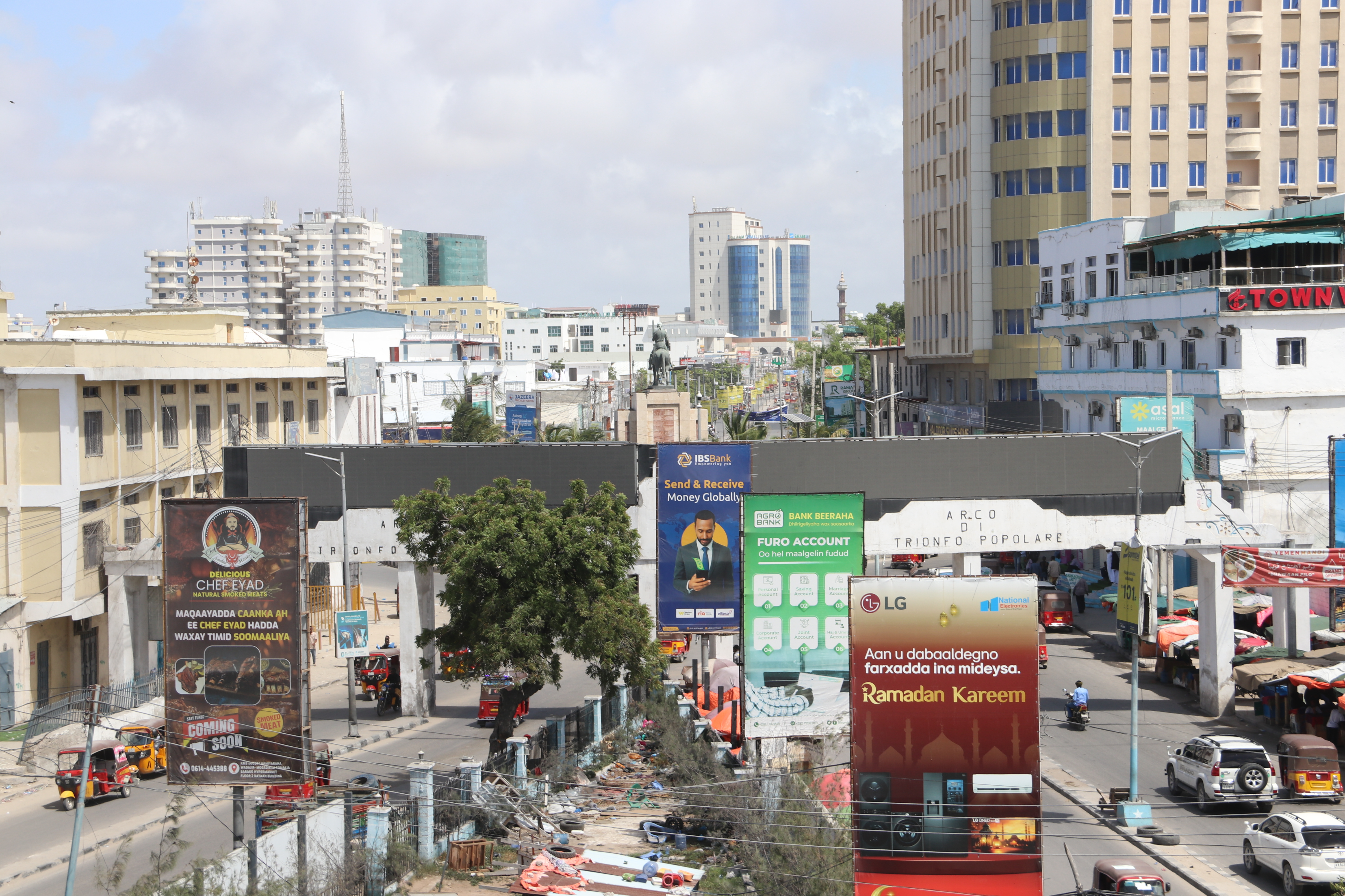 Maka Al Mukarama Road forms Mogadishu’s central business district, with the KM4 roundabout, the main junction in the city, hosts a statue of 16th-century Somali commander Ahmed Gurey. The area is a busy hub where families shop, socialise, and move between the capital’s key districts. [Faisal Ali/Al Jazeera]
