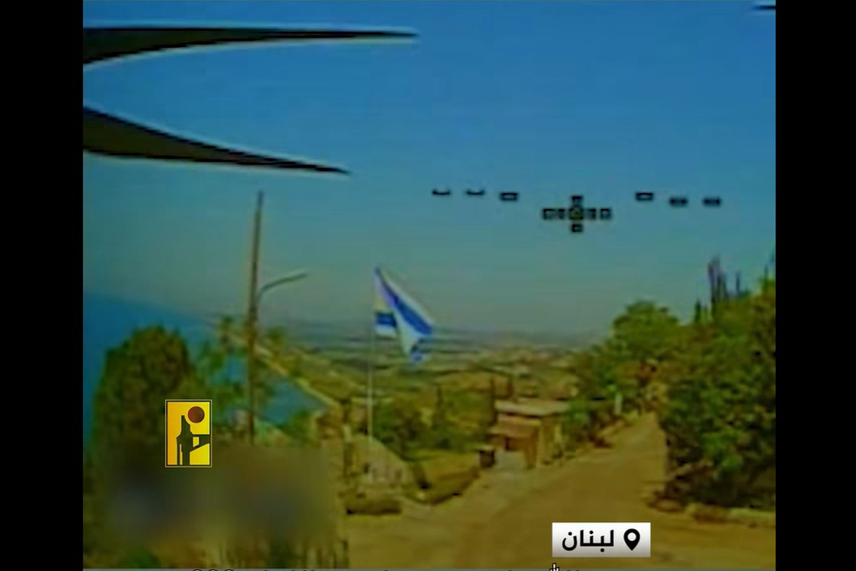 A screenshot of an FPV drone footage of an Israeli flag hoisted in a Lebanese village