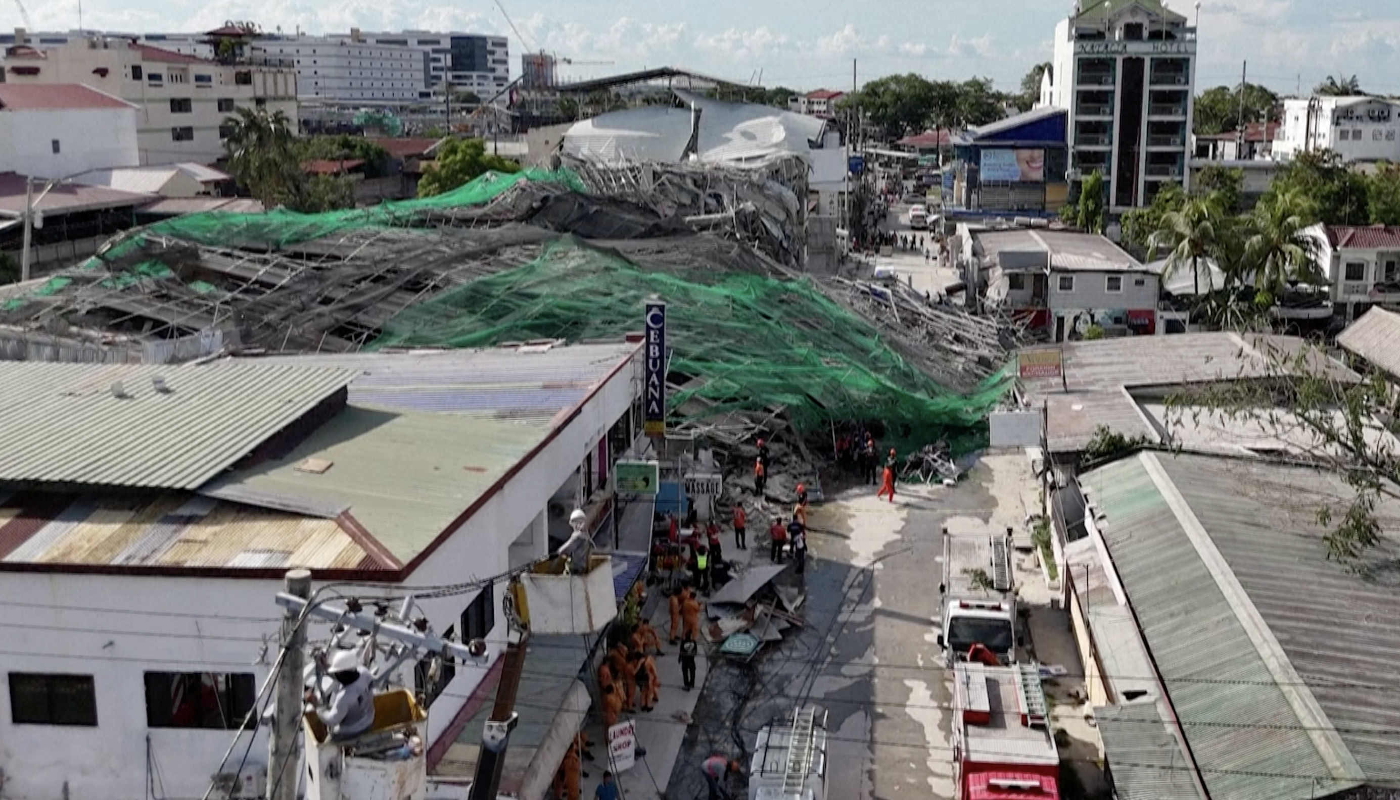 Rescuers are continuing to search for survivors trapped under the rubble a day after a hotel under construction collapsed, killing at least four people. Seventeen people are still missing, as their families gather at the scene for news.