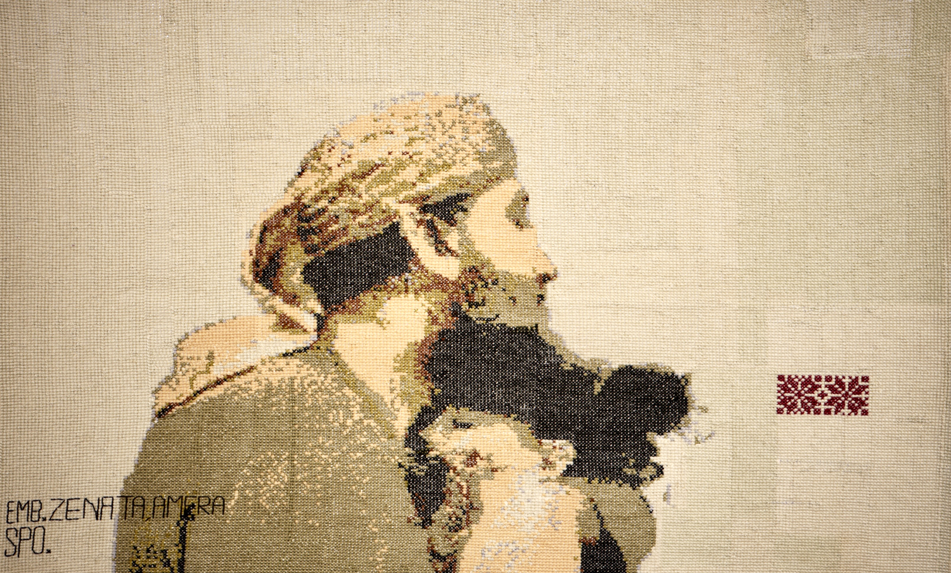 An embroidery of Khalid Nabhan hugging his dead granddaughter