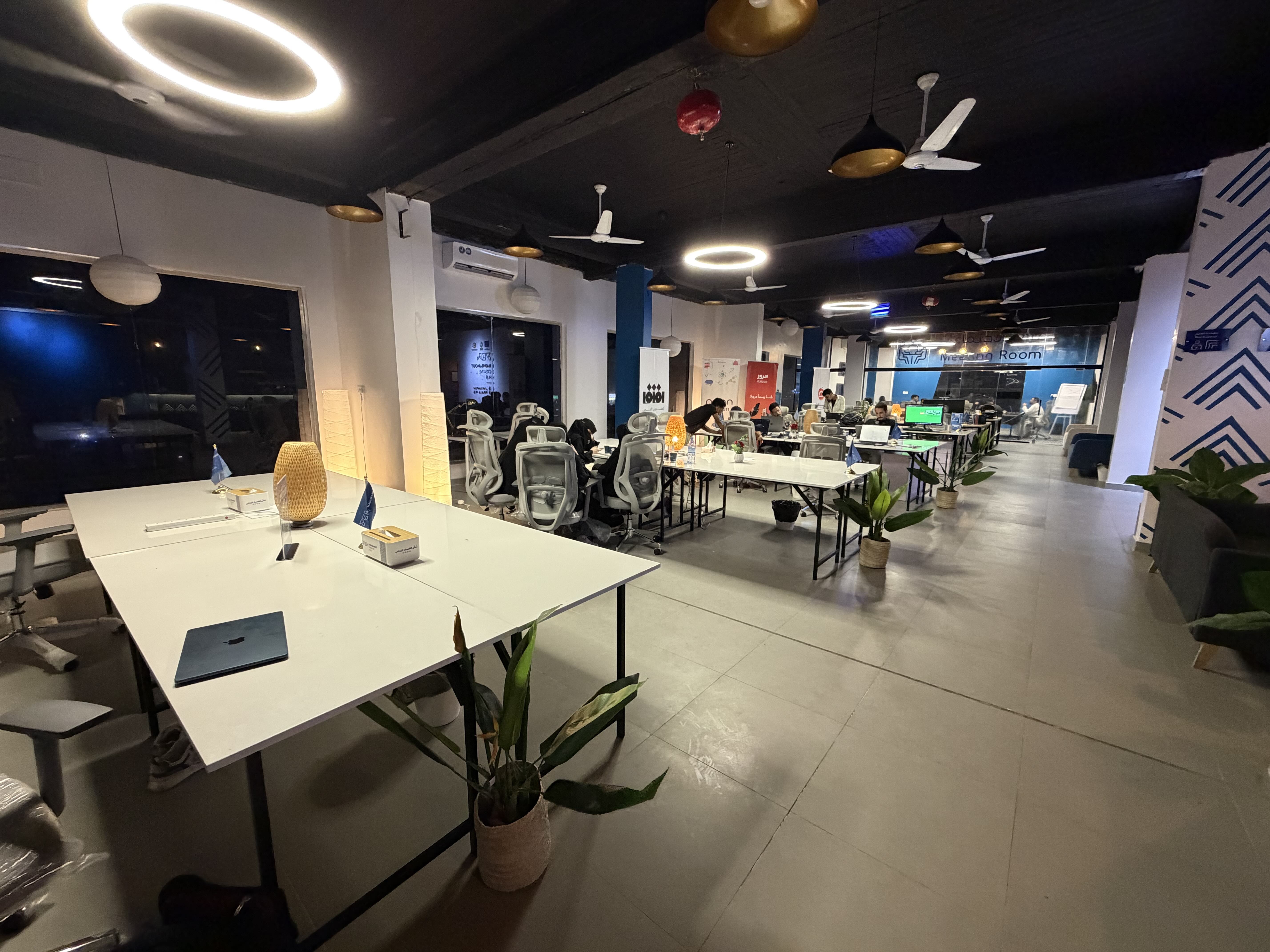 Wide shot of the Mukalla Creative Hub showing people working at desks with computers