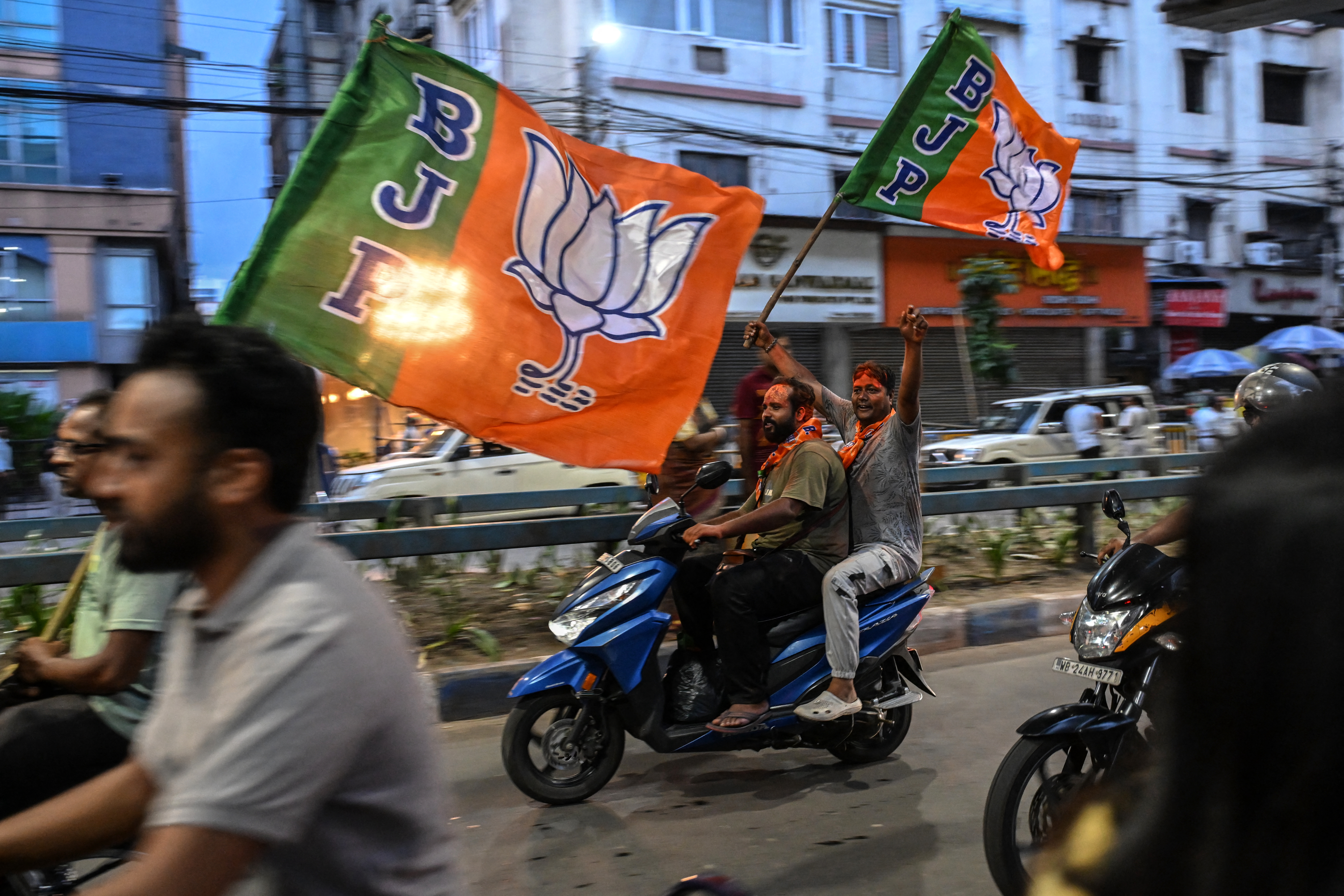 Bharatiya Janata Party (BJP) supporters celebrate after taking a lead during vote counting for the West Bengal Legislative Assembly elections in Kolkata on May 4, 2026.