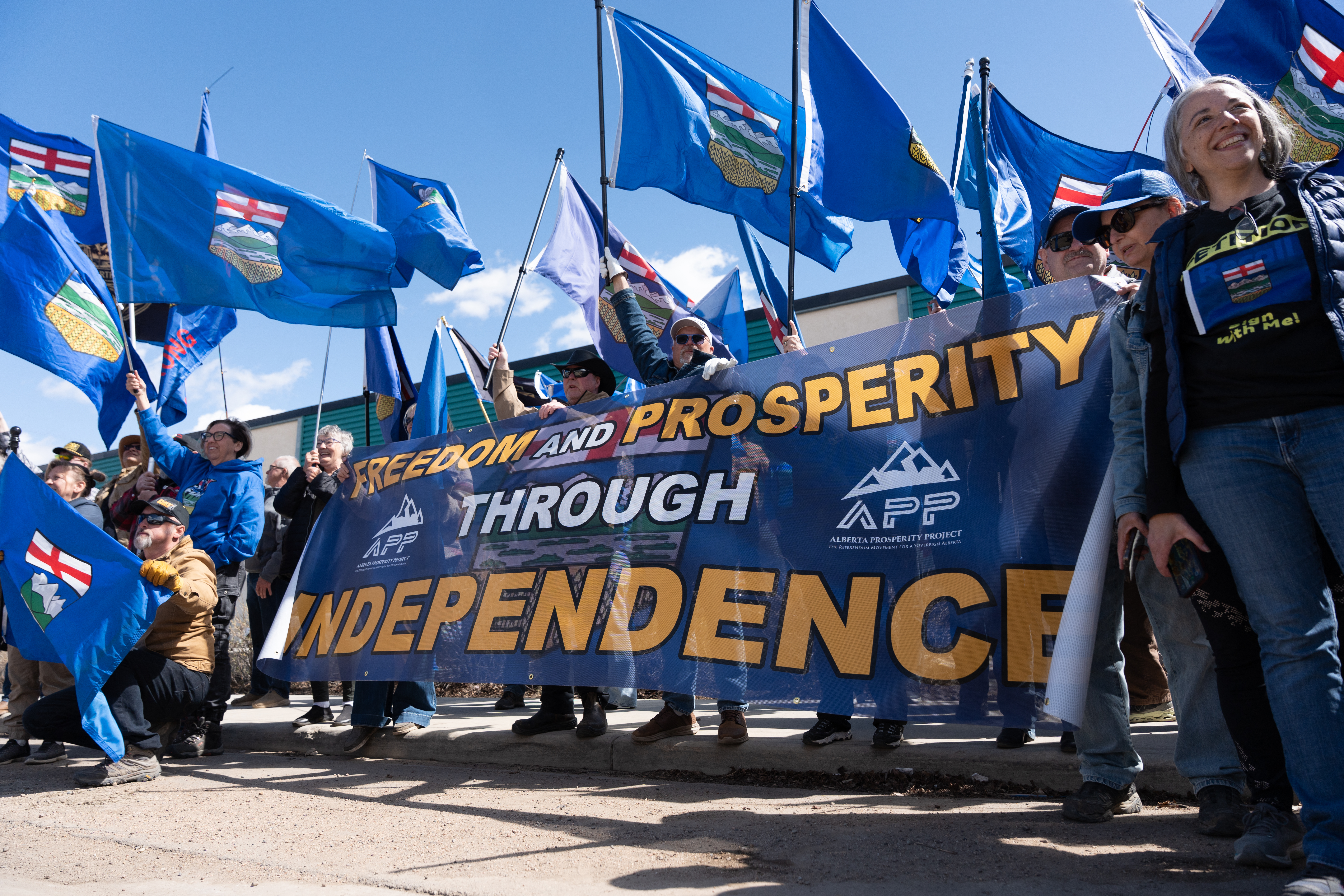 Separatist supporters gather during a rally in front of the Elections Alberta headquarters in Edmonton, Canada, on May 4, 2026, as they submit boxes of signatures in the hope of triggering an independence referendum.