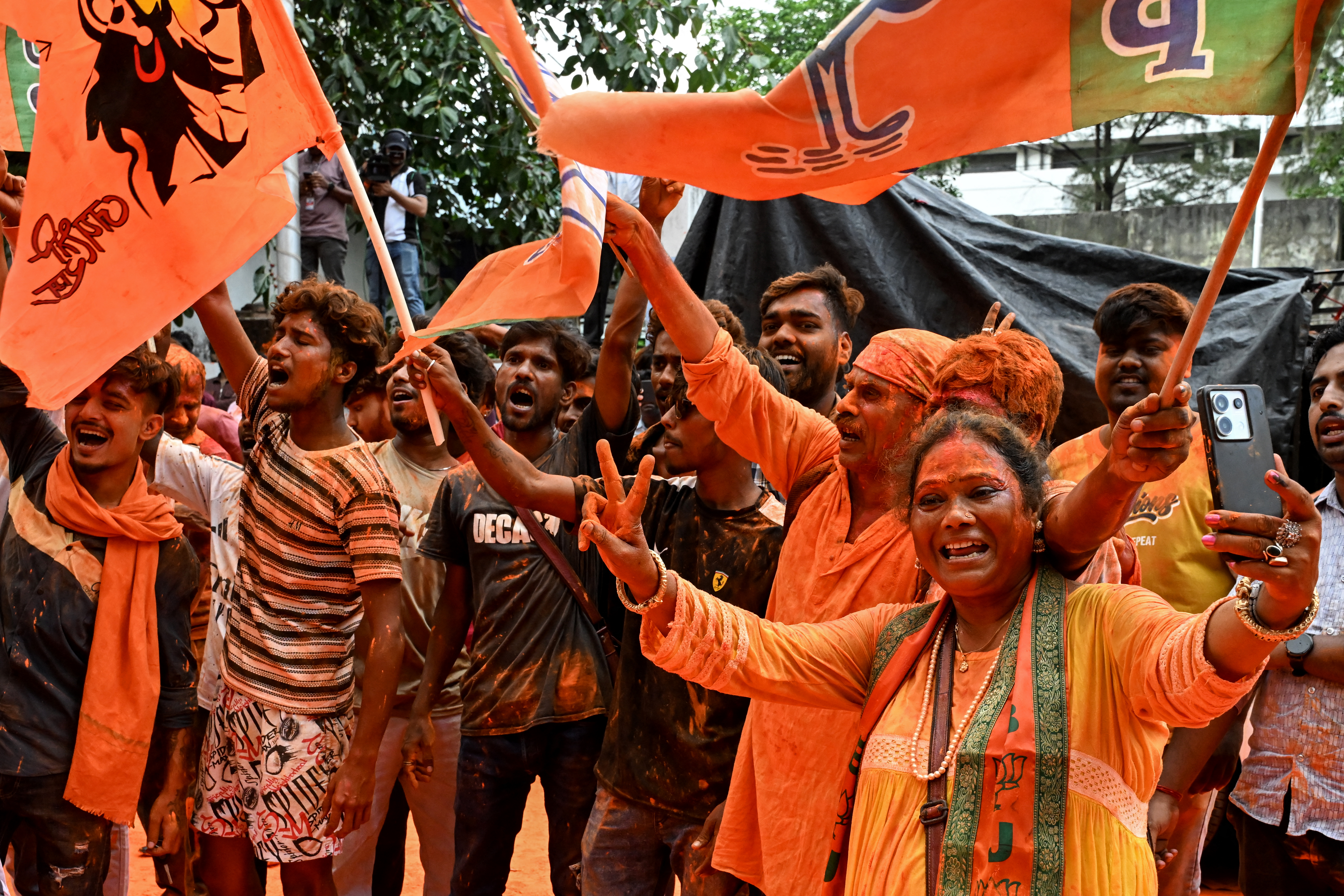 Bharatiya Janata Party (BJP) supporters celebrate after taking a lead during vote counting for the West Bengal Legislative Assembly elections, near the party head office in Kolkata on May 4, 2026.