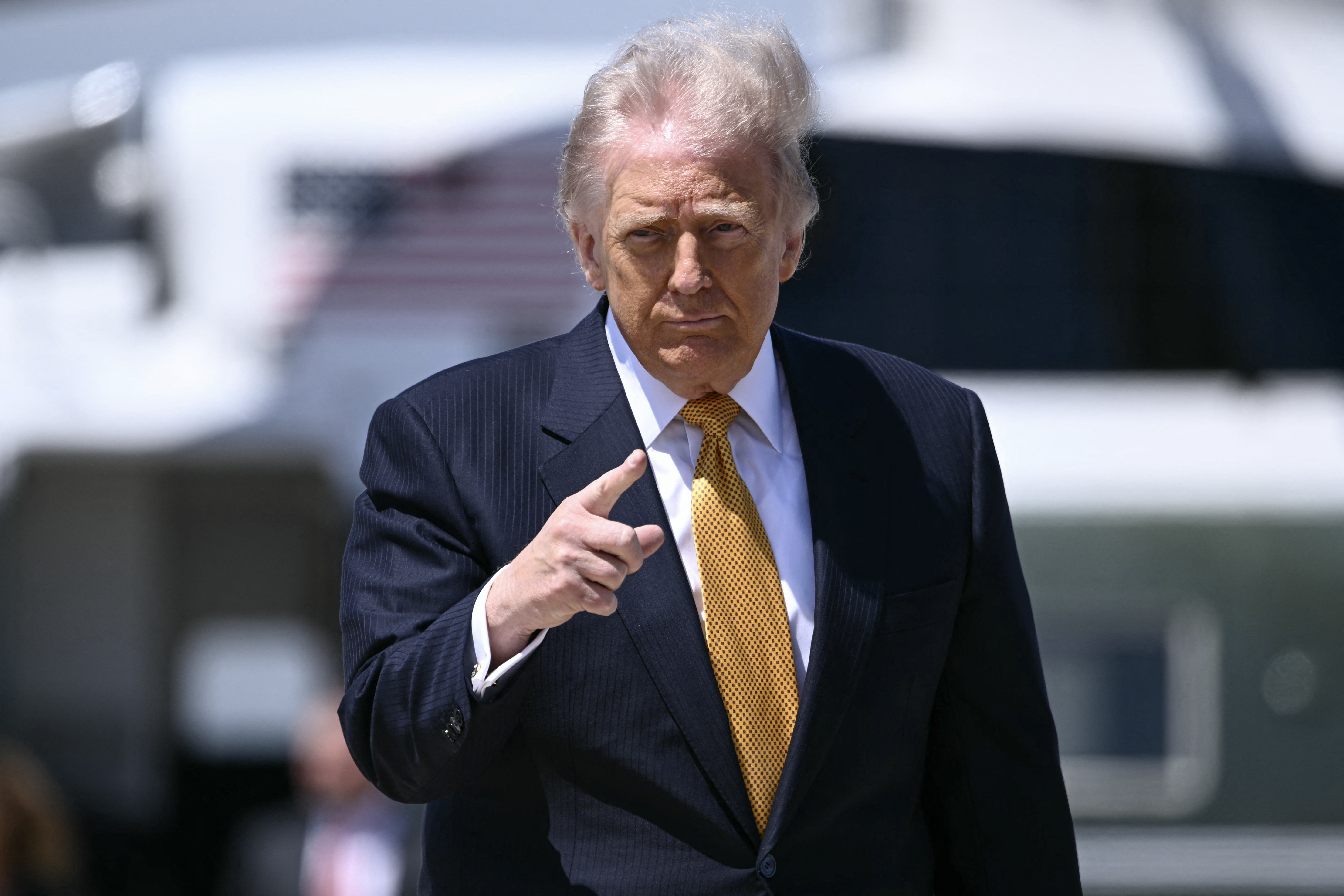 US President Donald Trump gestures before boarding Air Force One.
