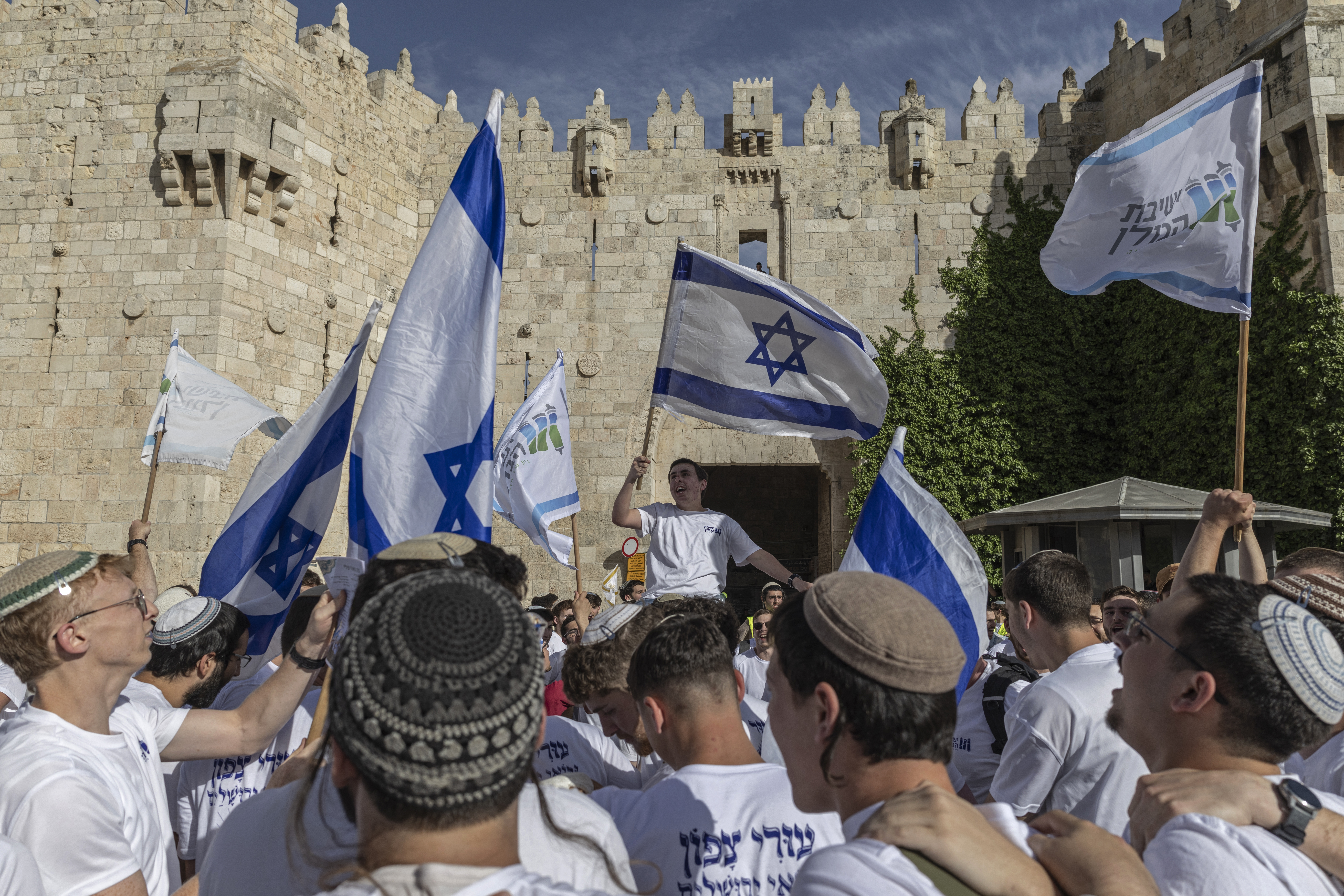 Israeli settlers take part in the Jerusalem Day parade at the Damascus Gate in the old city of Jerusalem on May 14, 2026.