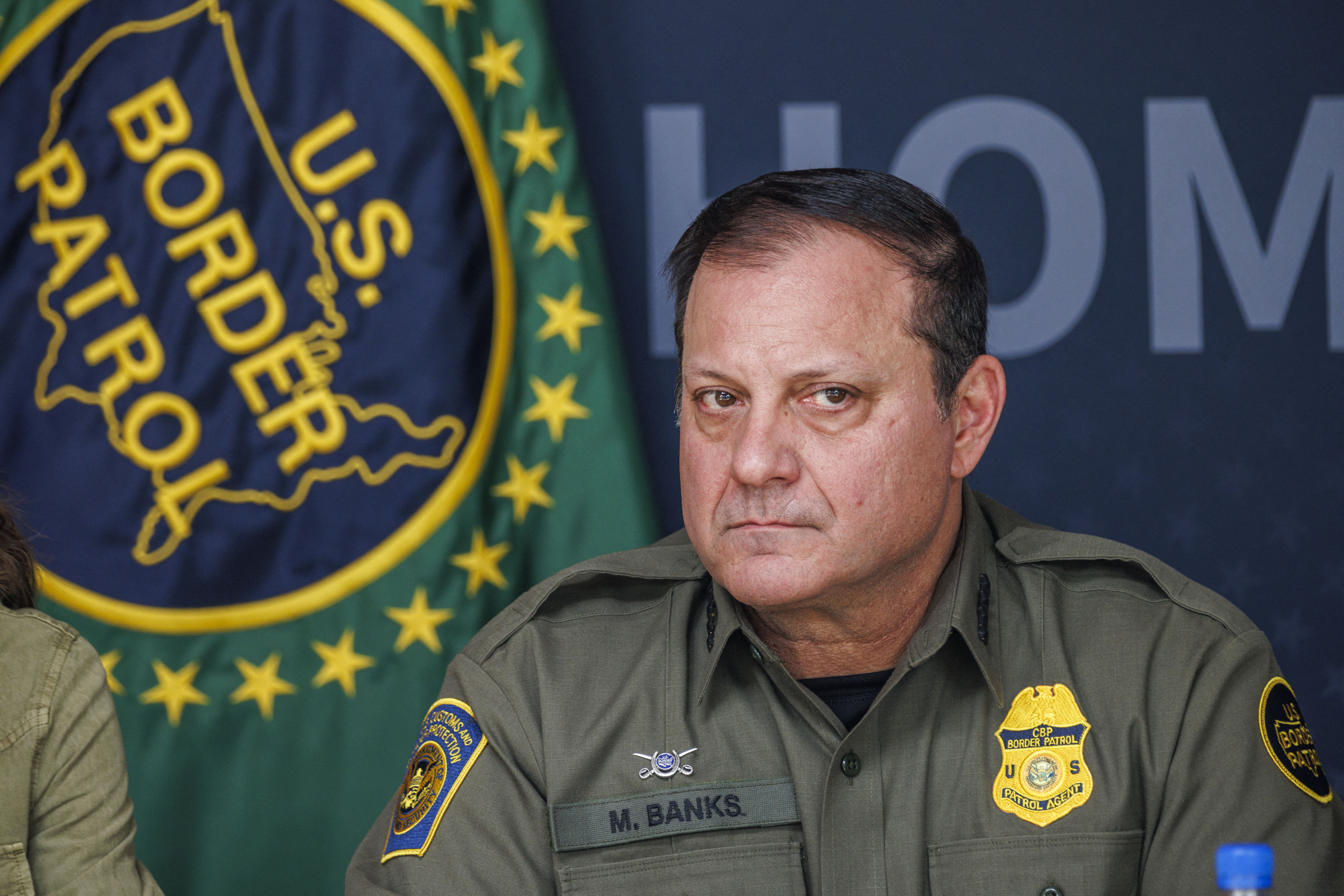(FILES) US Border Patrol Chief Mike Banks looks at a roundtable discussion with local ranchers and employees from Customs and Border Protection led by Secretary of Homeland Security Kristi Noem on January 7, 2026 in Brownsville, Texas.