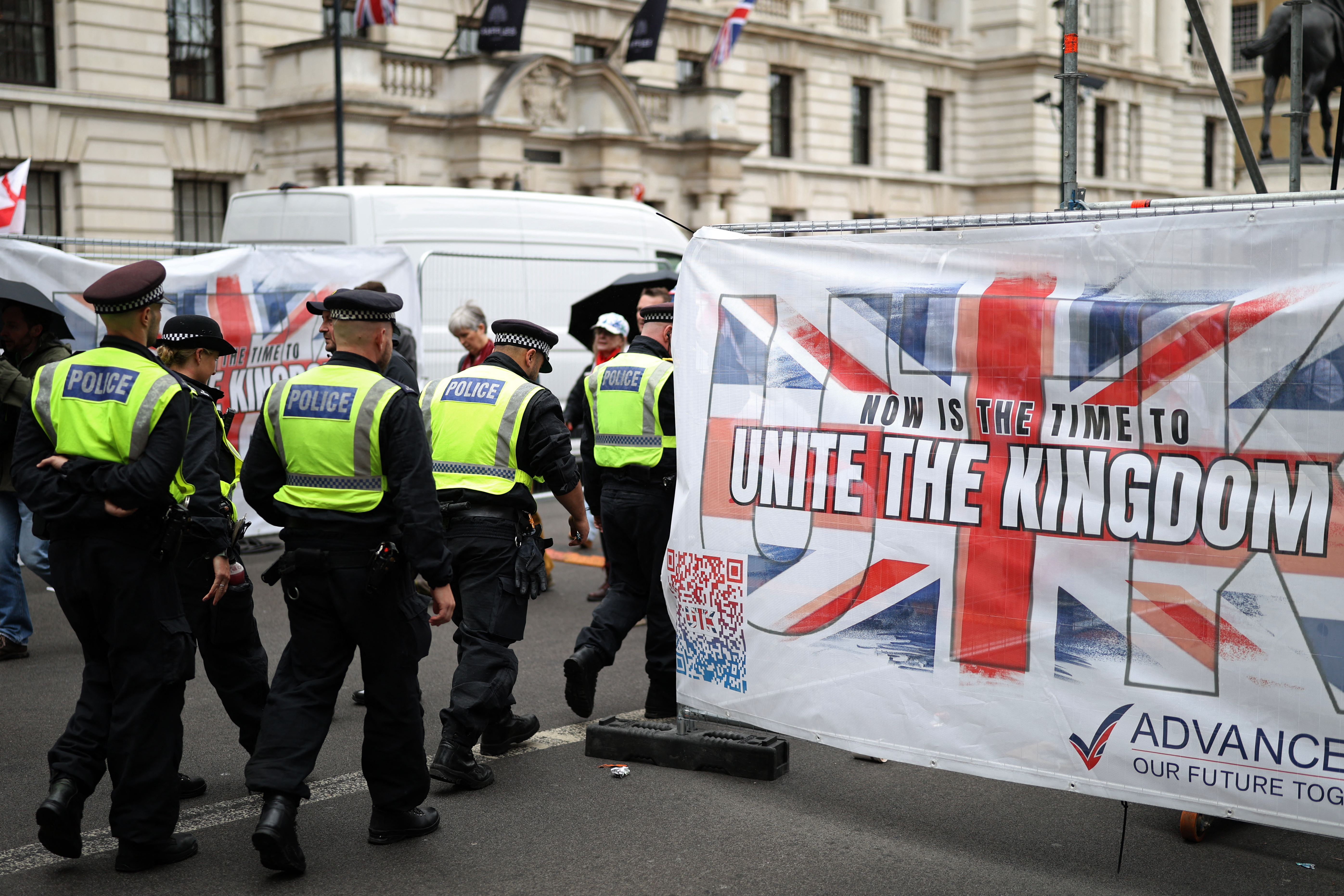 Police officers begin to move off after a march organised by Unite The Kingdom, in central London on May 16, 2026.