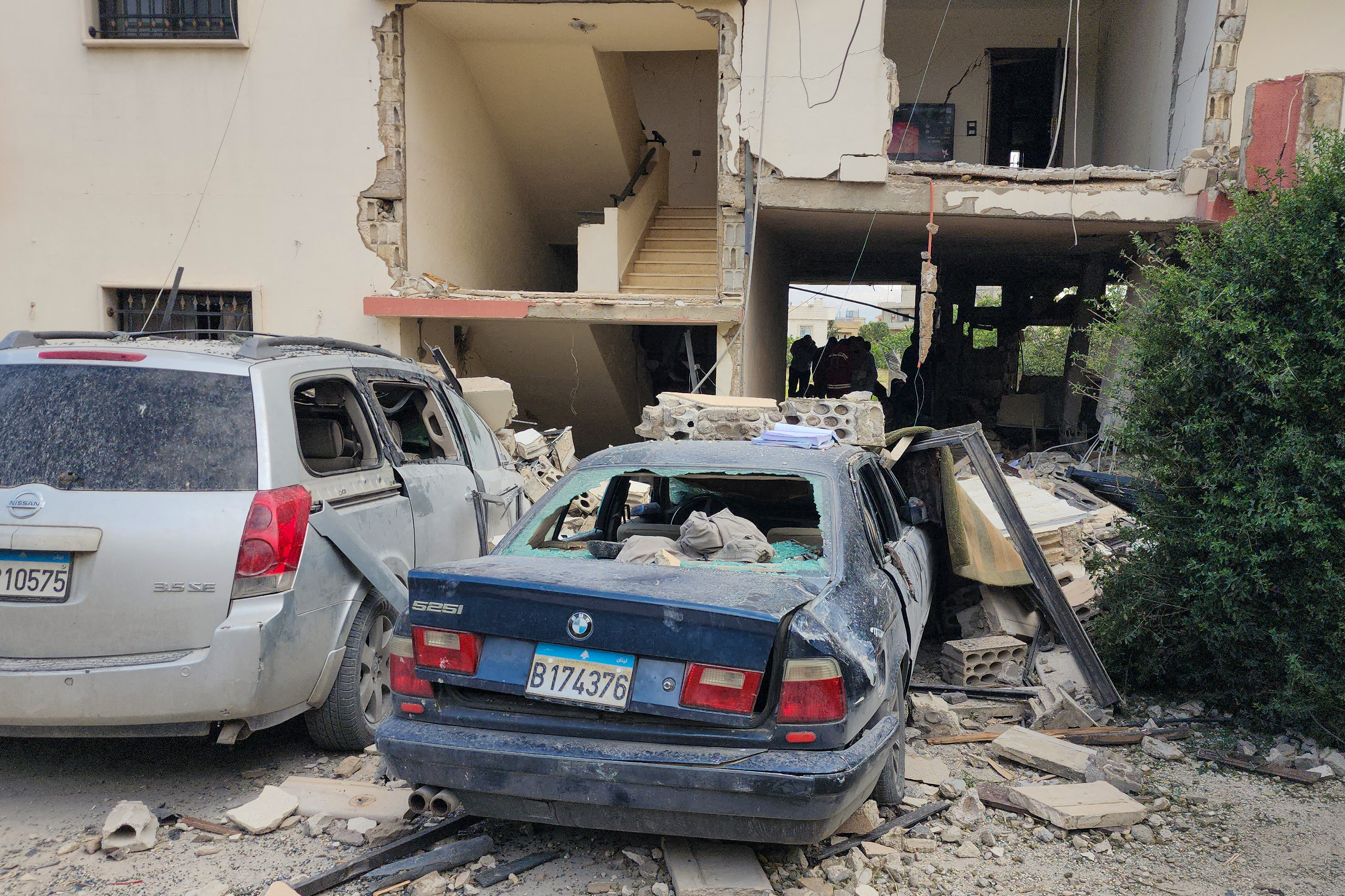 TOPSHOT - Emergency workers inspect the damage following an Israeli strike on an apartment building in Baalbek on May 18, 2026.