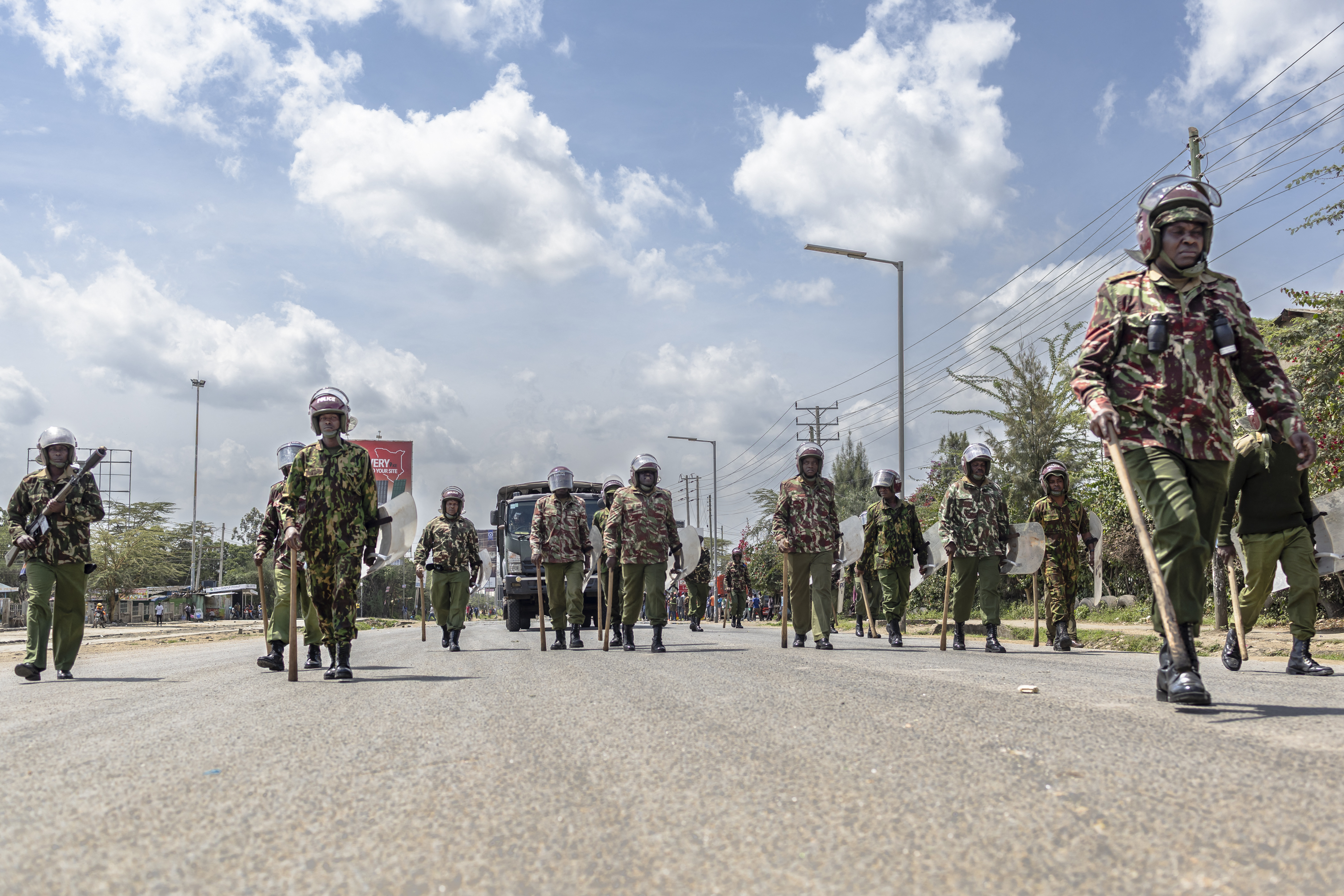 Kenyan anti-riot police advance on a crowd of protesters along Namanga road during a nationwide transport strike over rising fuel prices in Kitengela on May 18, 2026.