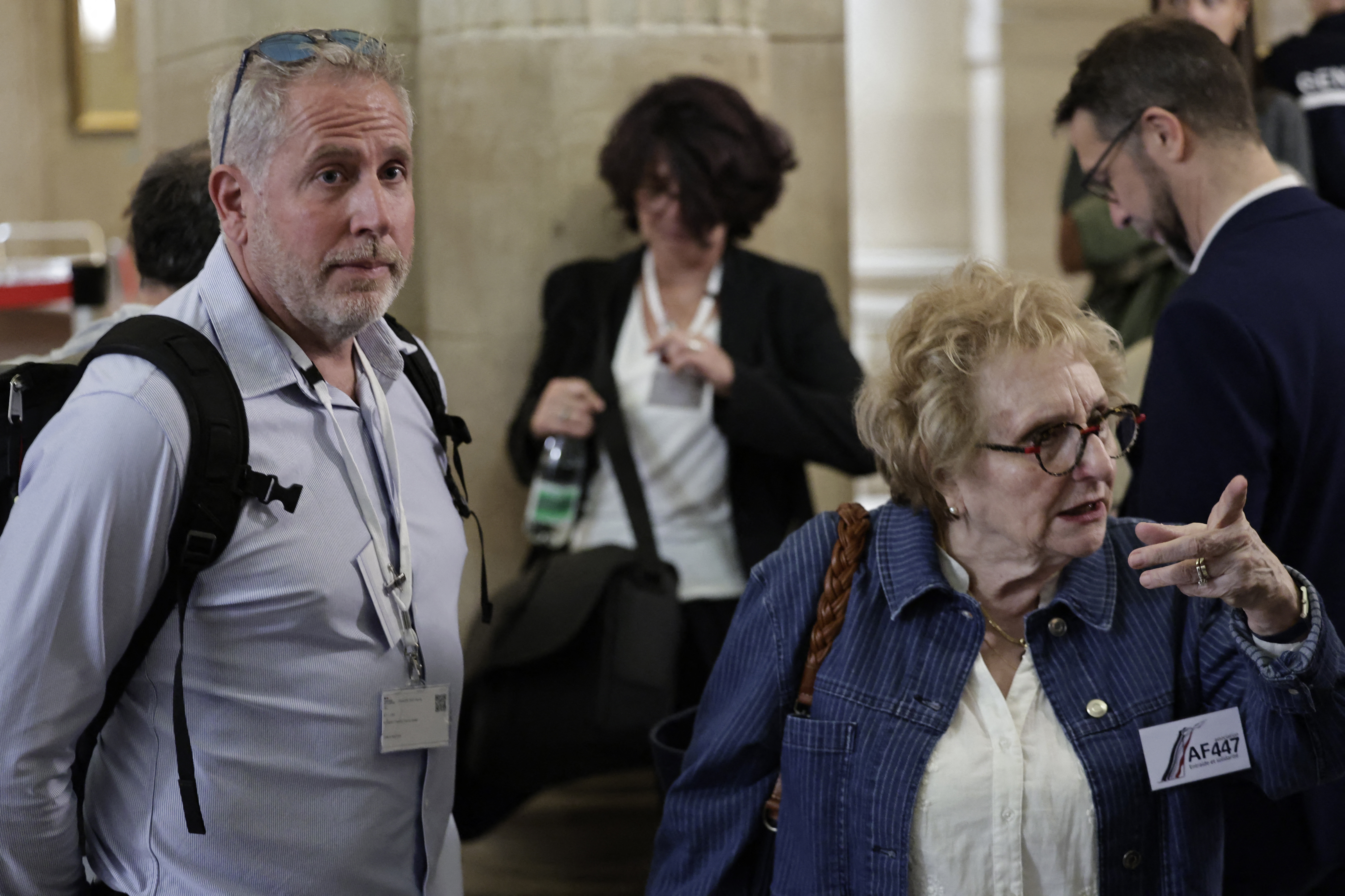 Teddy Robert (L), brother of flight AF447's co-pilot, and Daniele Lamy (R), president of victims' families association Entraide et Solidarite AF447, stand outside the courthouse on Ile de la Cite in Paris ahead of the verdict in the trial of Airbus and Air France on charges of manslaughter in connection with the 2009 Rio-Paris flight crash, on May 21, 2026. (Photo by STEPHANE DE SAKUTIN / AFP)