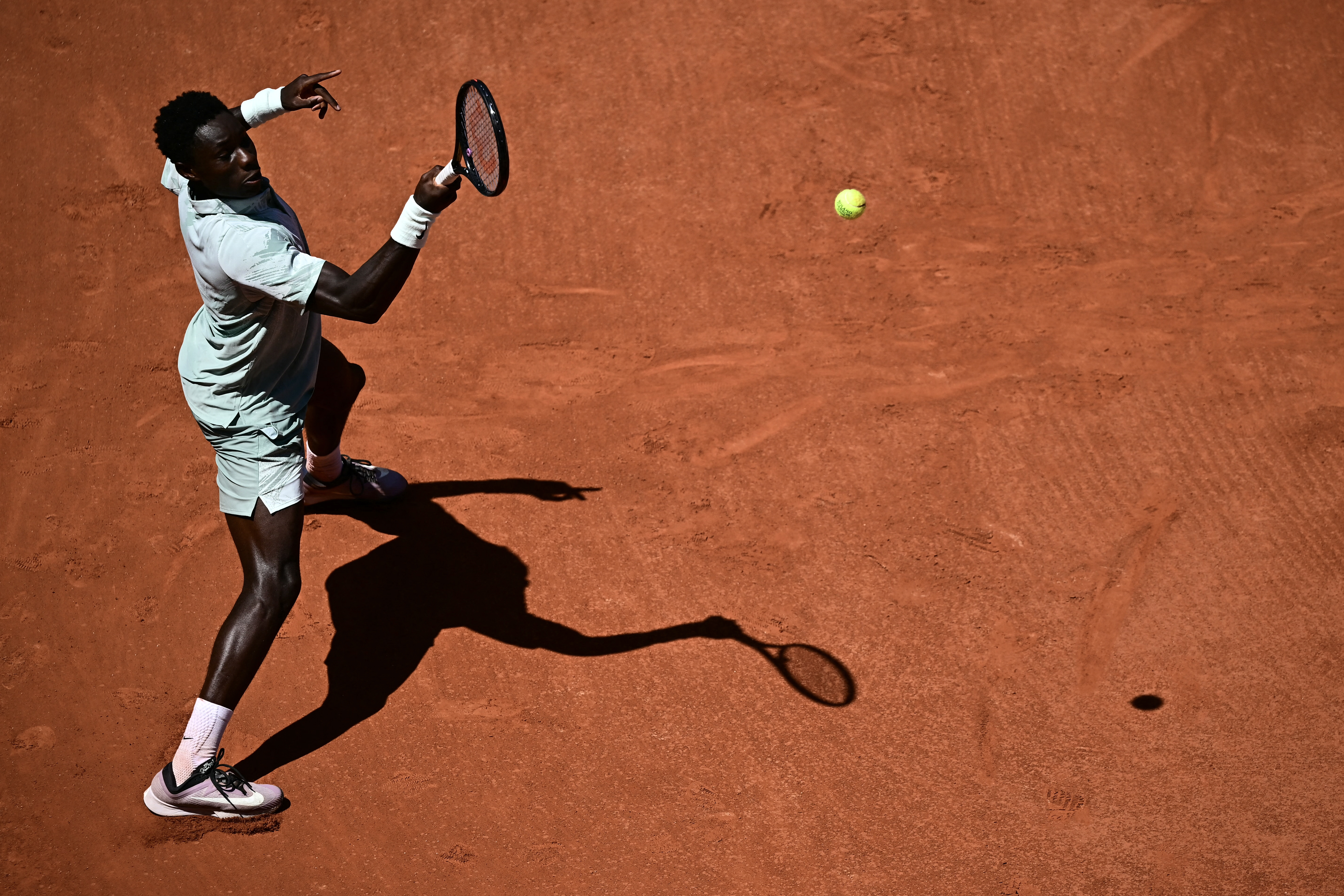 France's Moise Kouame plays a forehand return to Croatia's Marin Cilic during their men's singles match on day 3 of the French Open tennis tournament on Court Simonne-Mathieu at the Roland-Garros Complex in Paris on May 26, 2026. (Photo by JULIEN DE ROSA / AFP)