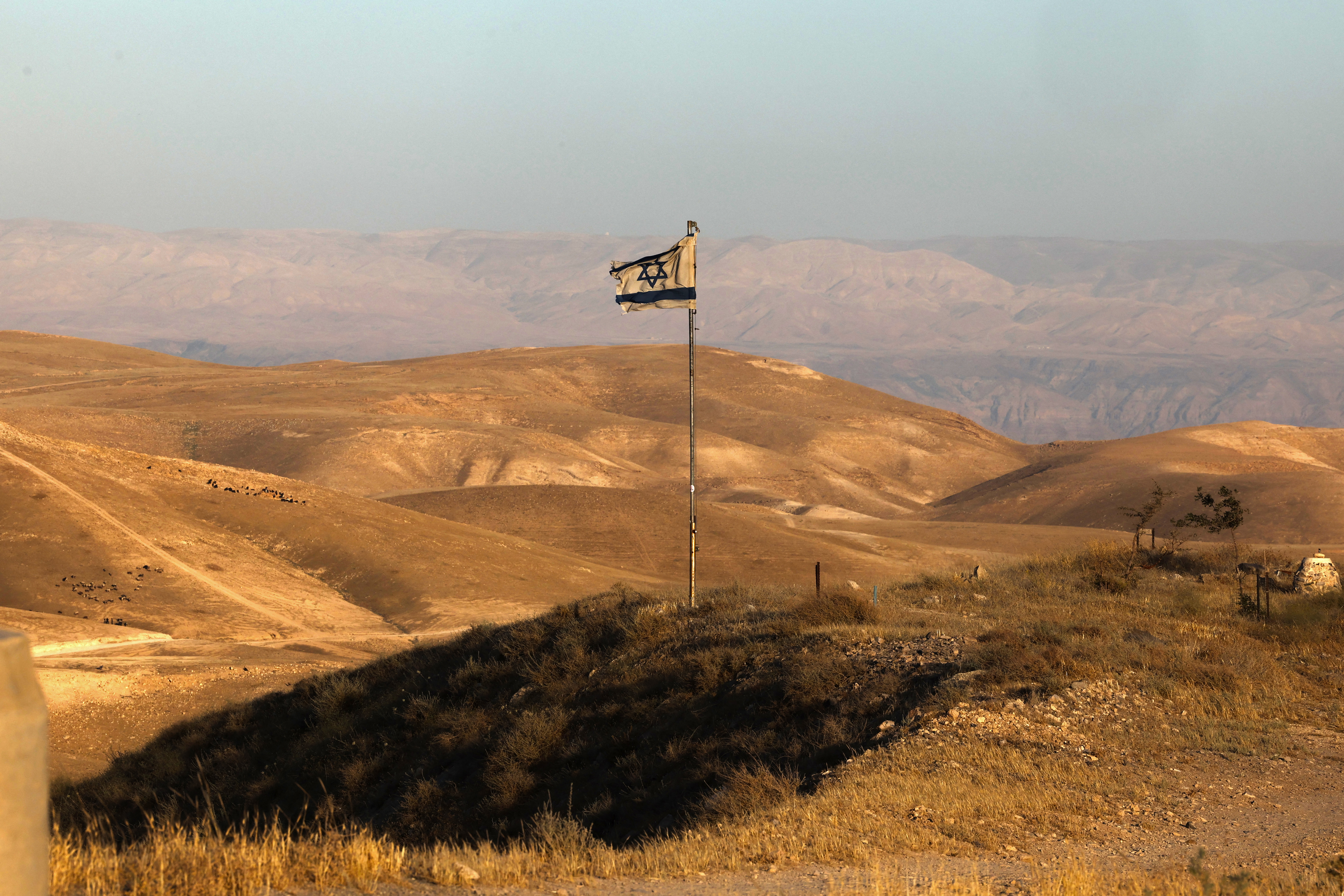 An Israeli flag flutters near Khan al-Ahmar in the Israeli-occupied West Bank on May 20, 2026.