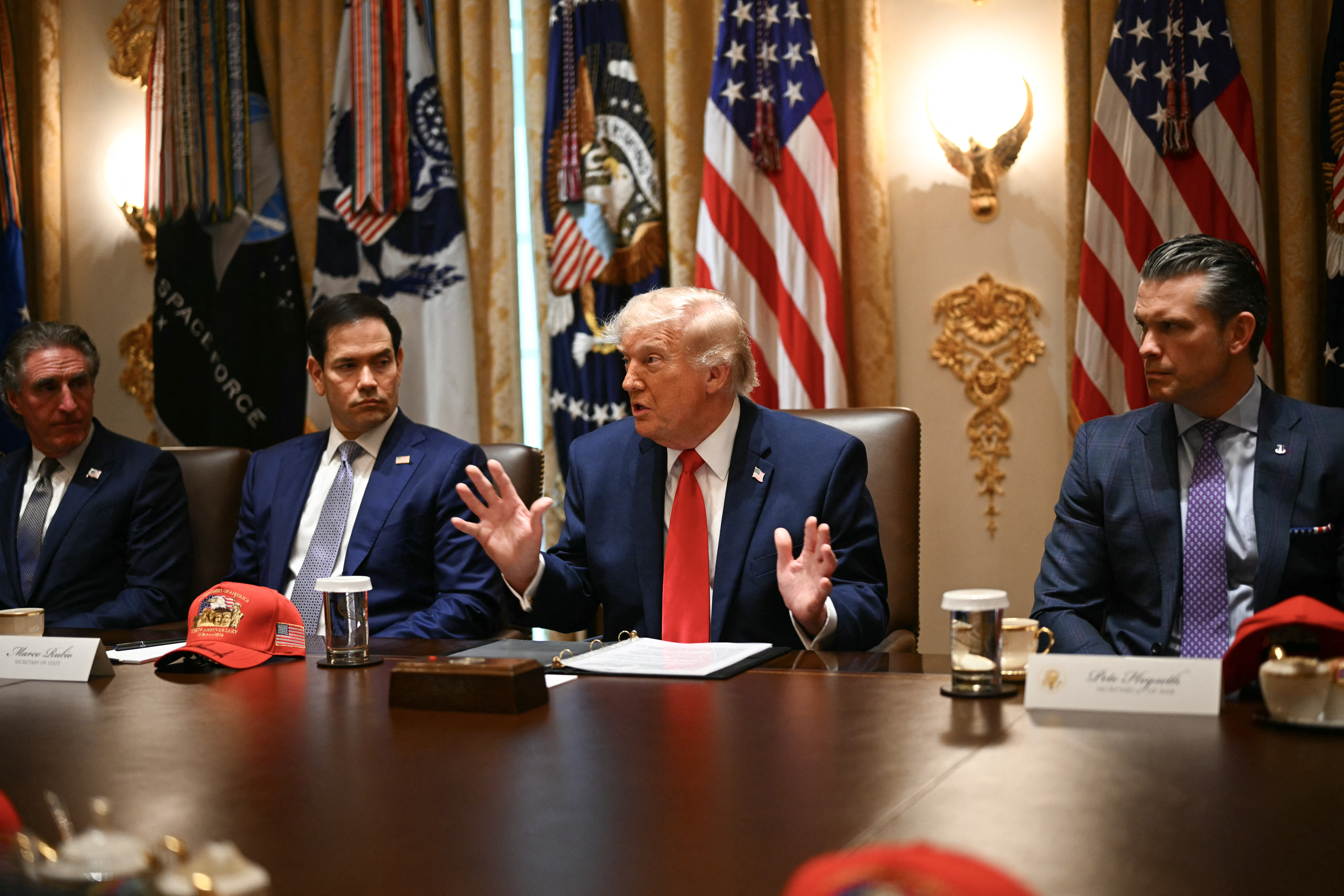 US Secretary of the Interior Doug Burgum (L), US Secretary of State Marco Rubio (2nd L) and US Defense Secretary Pete Hegseth (R) listen to US President Donald Trump speak during a cabinet meeting in the Cabinet Room of the White House in Washington, DC, on May 27, 2026. (Photo by Kent NISHIMURA / AFP)