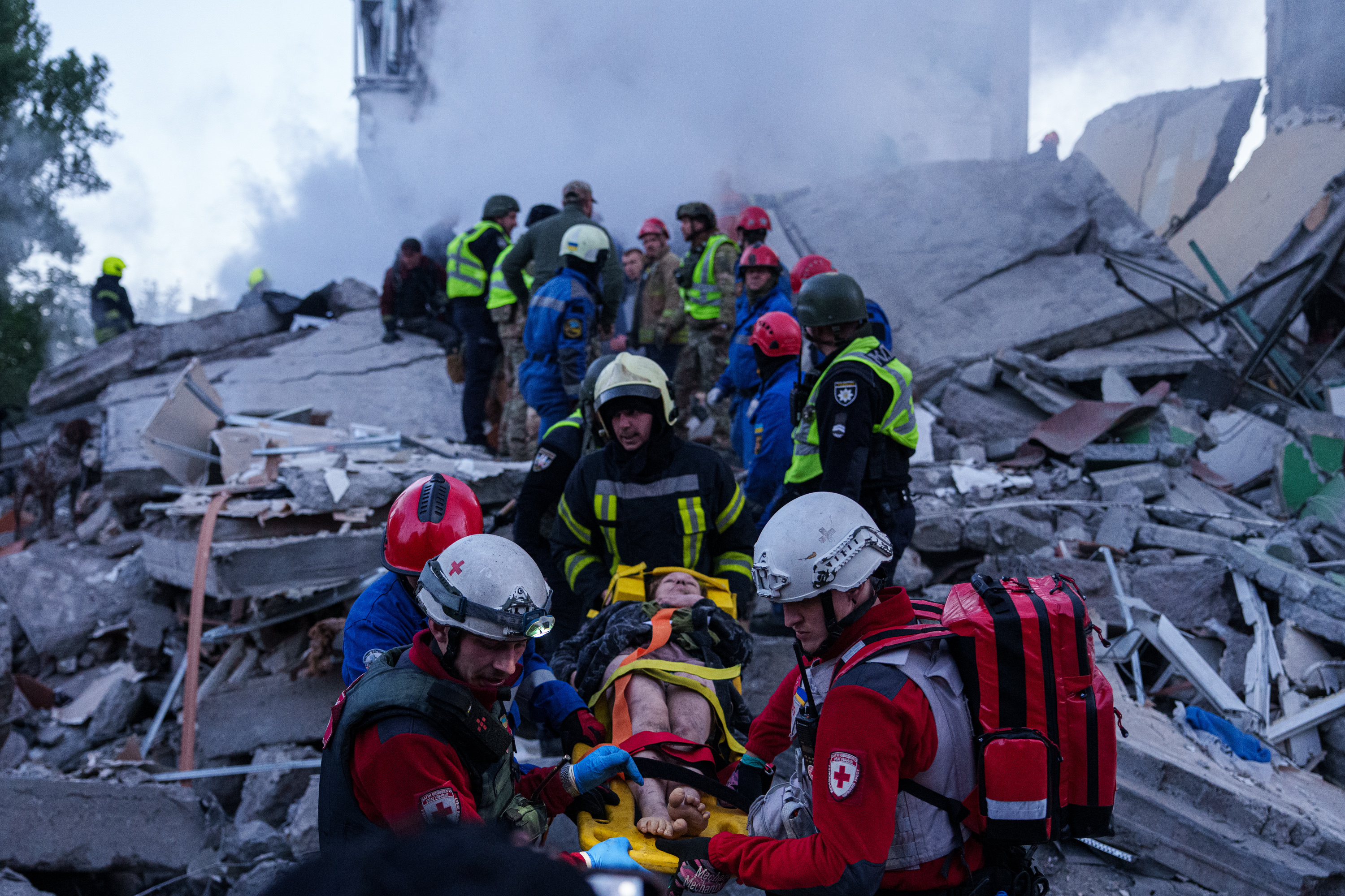 Rescue workers carry an injured woman on a stretcher from a house heavily damaged after a Russian strike on residential neighbourhood in Kyiv, Ukraine, on Thursday, May 14, 2026. (AP Photo/Evgeniy Maloletka)